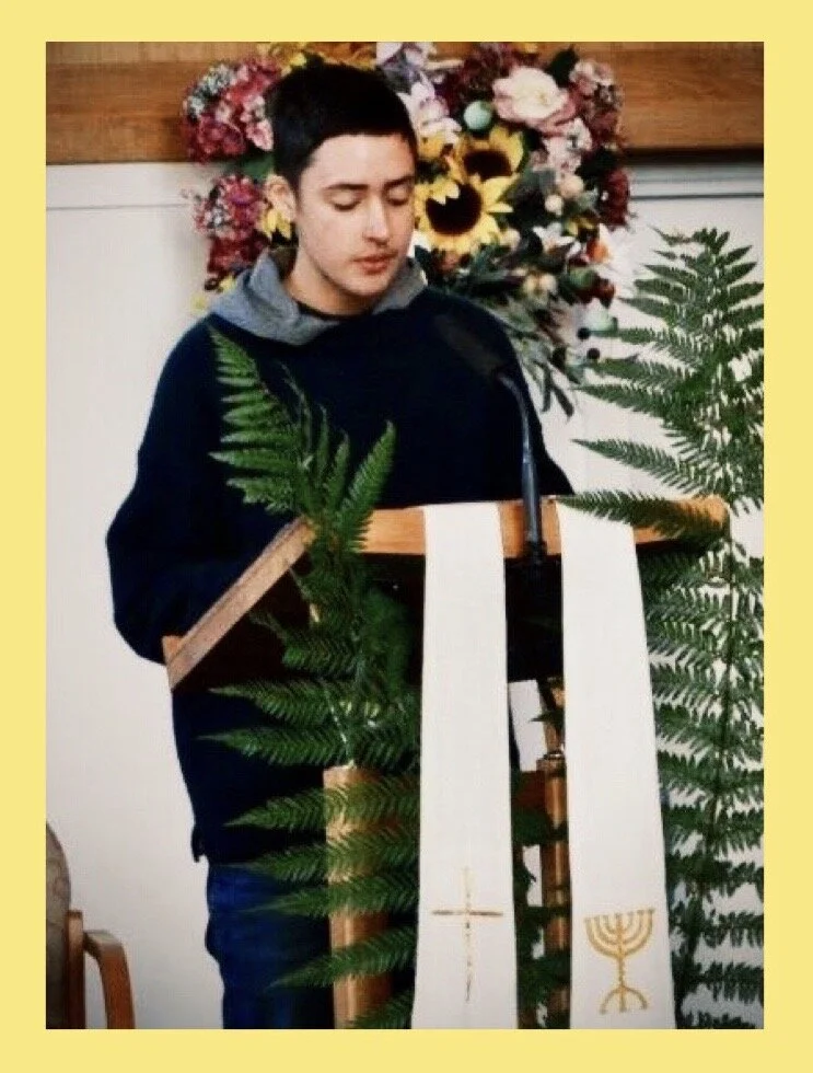 Teen giving speech with grass.JPG