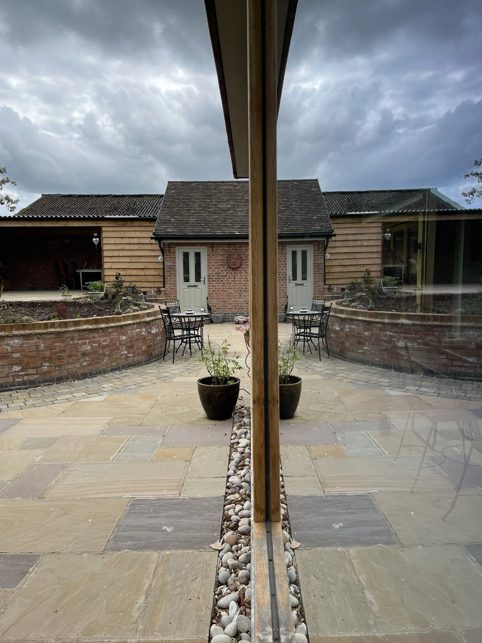 Substantial extensions and alterations to an existing farmhouse comprising traditional materials, oak framed structures and large areas of glazing. Design by James Fleming Architectural Ltd. #reflectiveimage #glazedfeature