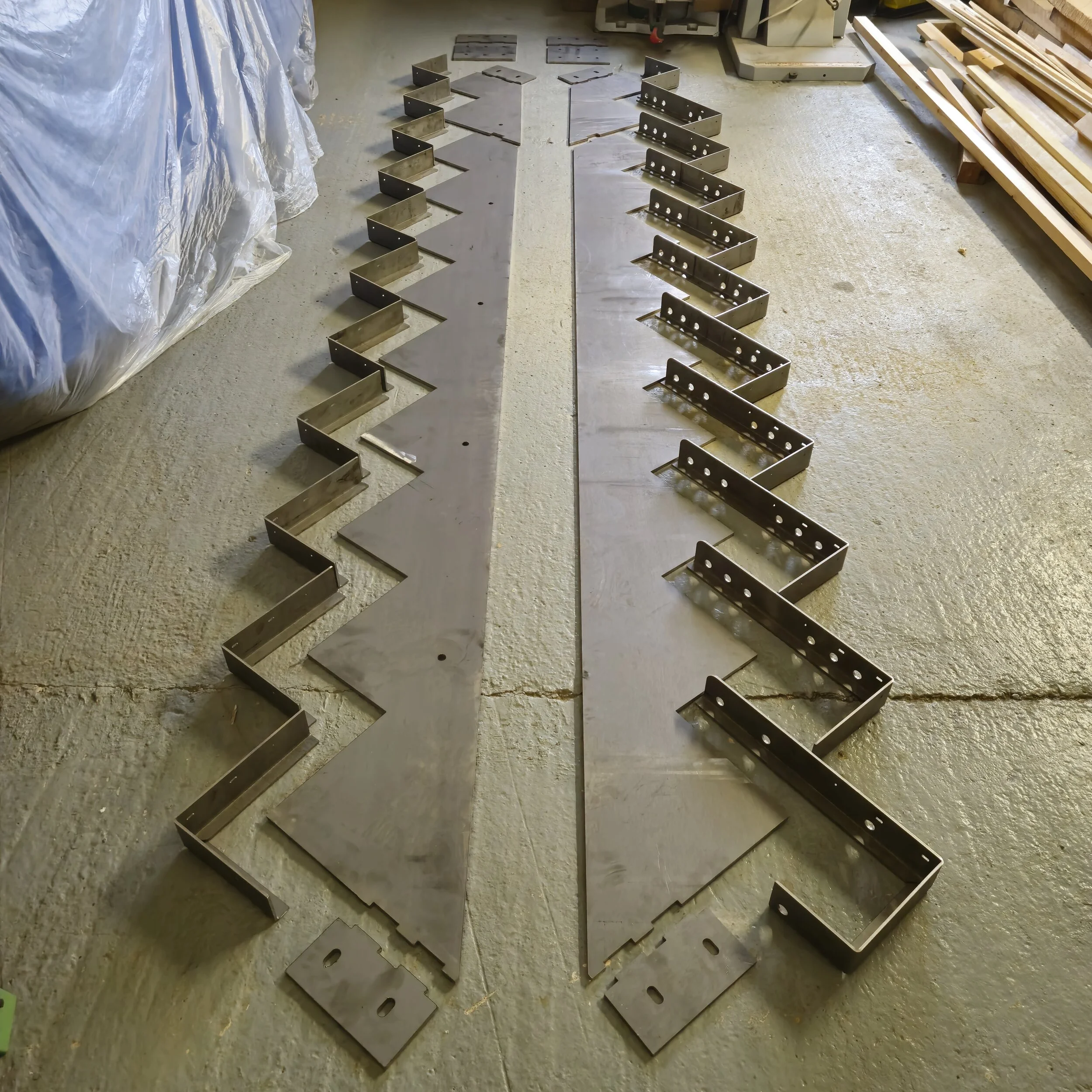 Laser cut and folded metal work to make stringers for a staircase.