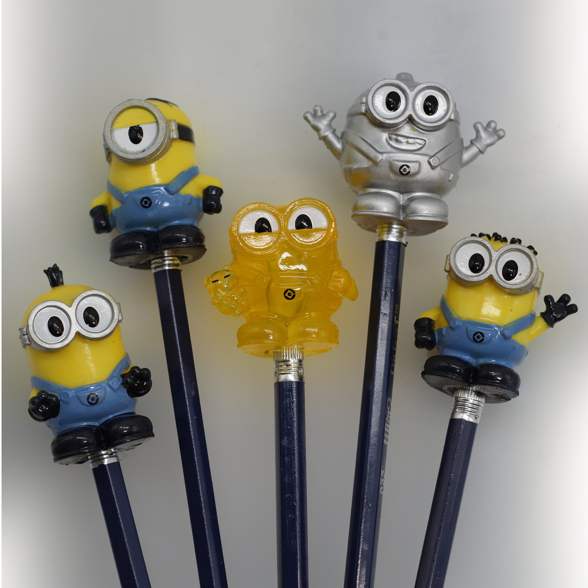 HH100000 Minions 5 pack Pencil Toppers oop on blue pencils.jpg
