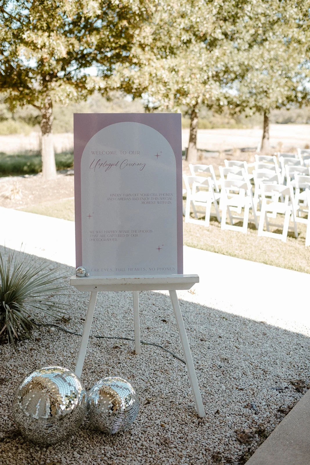 outdoor ceremony with pink lights and paper sign, in the style of soft tonal shifts, cosmic inspiration, curved mirrors, traditional-modern fusion, detail-oriented, celestial -