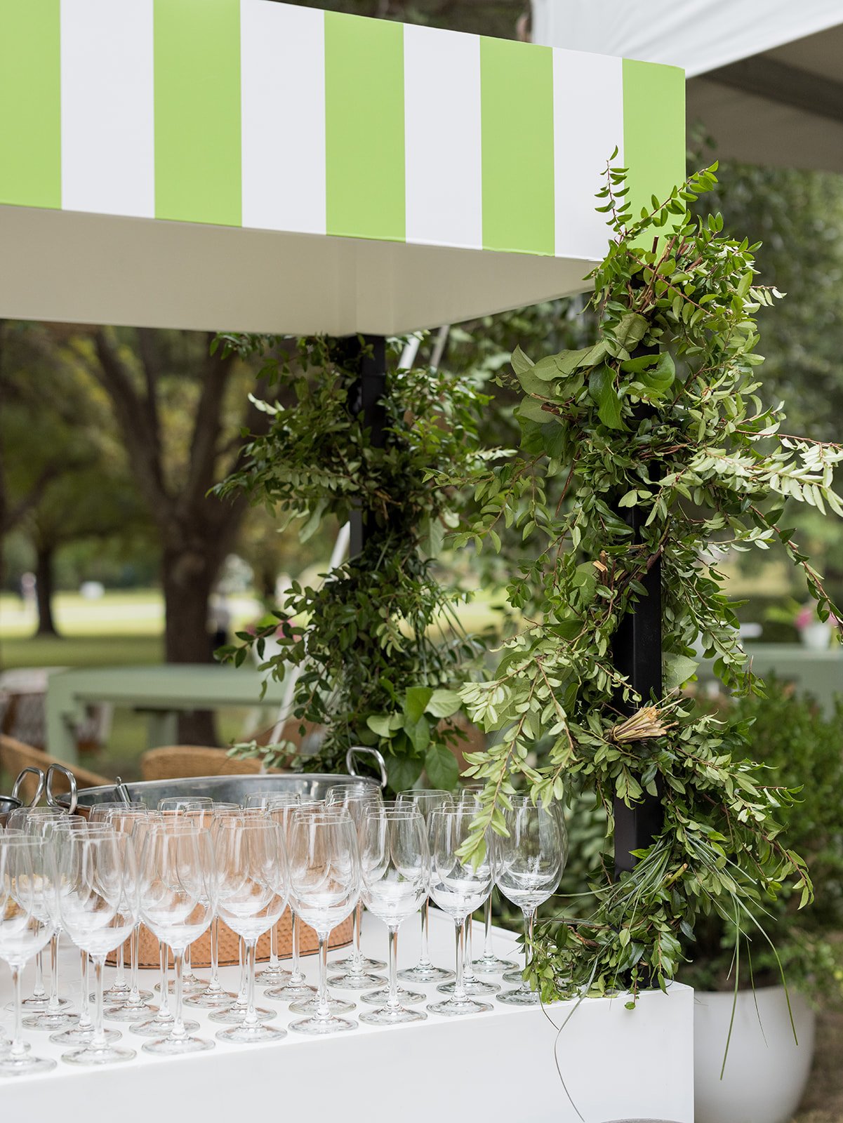 Glassware Display Under Green and White Striped Awning