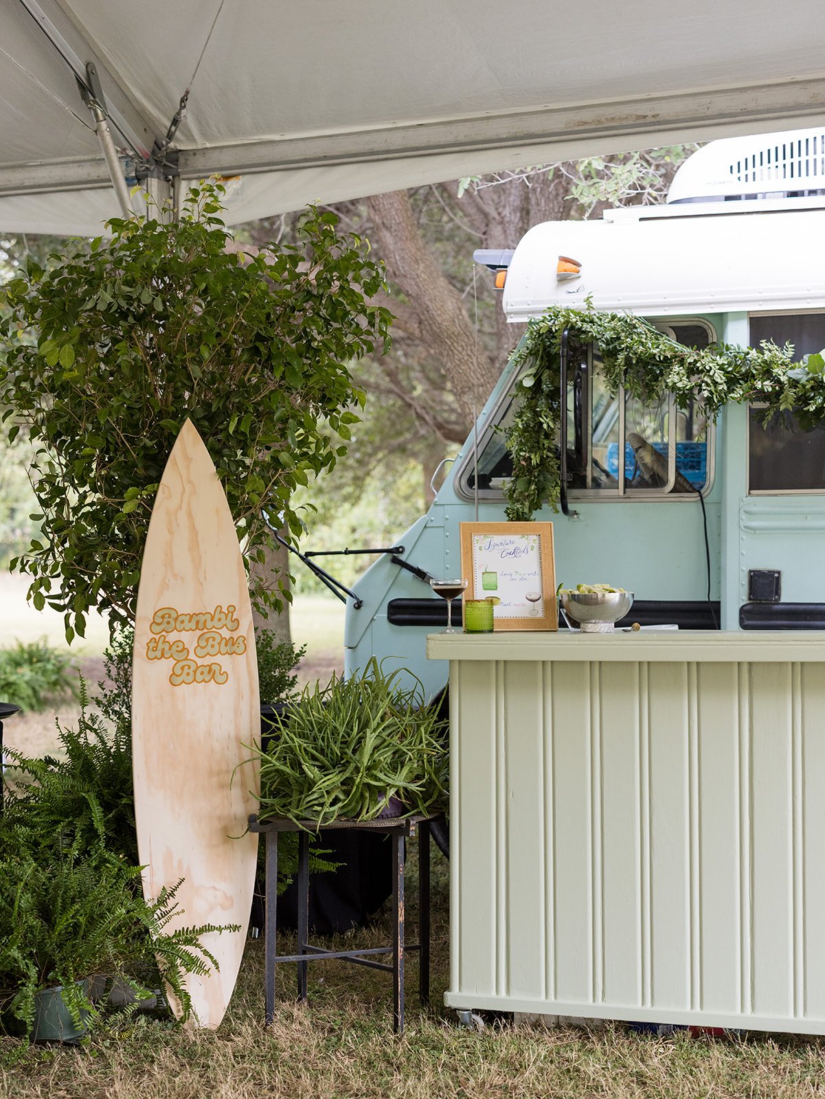 Custom Cocktail Bar with Surfboard Sign and Greenery