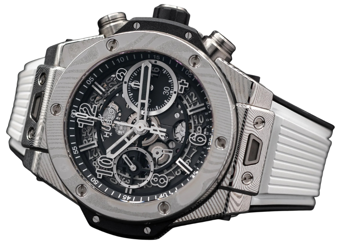 Close-up of a luxury Hublot wristwatch with a black and silver face, multiple dials, and a metal and rubber band.