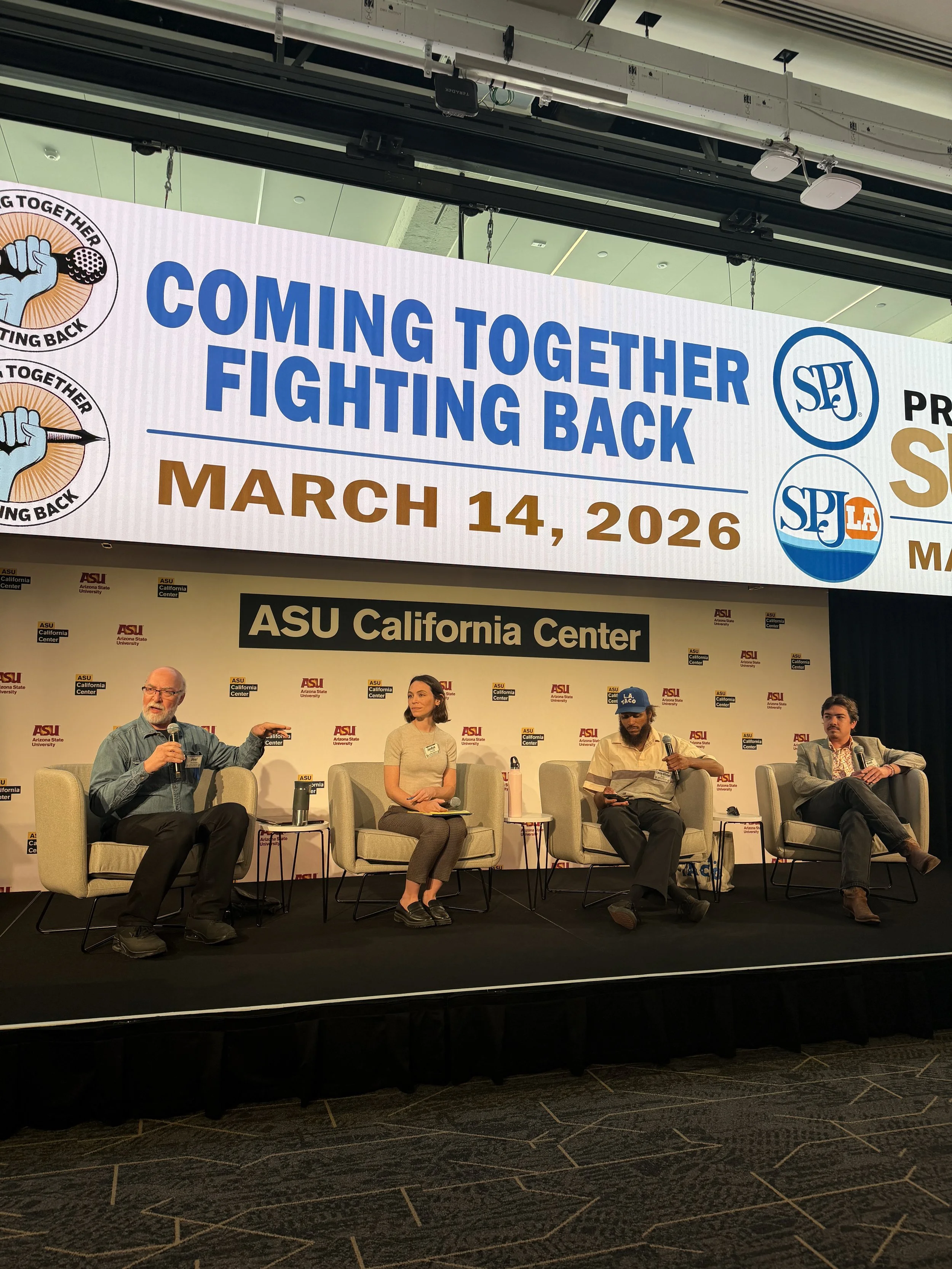 Three men and one woman sit on chairs on a stage in front of a sign that reads ASU California Center. The text on the screen above them reads Coming Together Fighting Back March 14, 2026