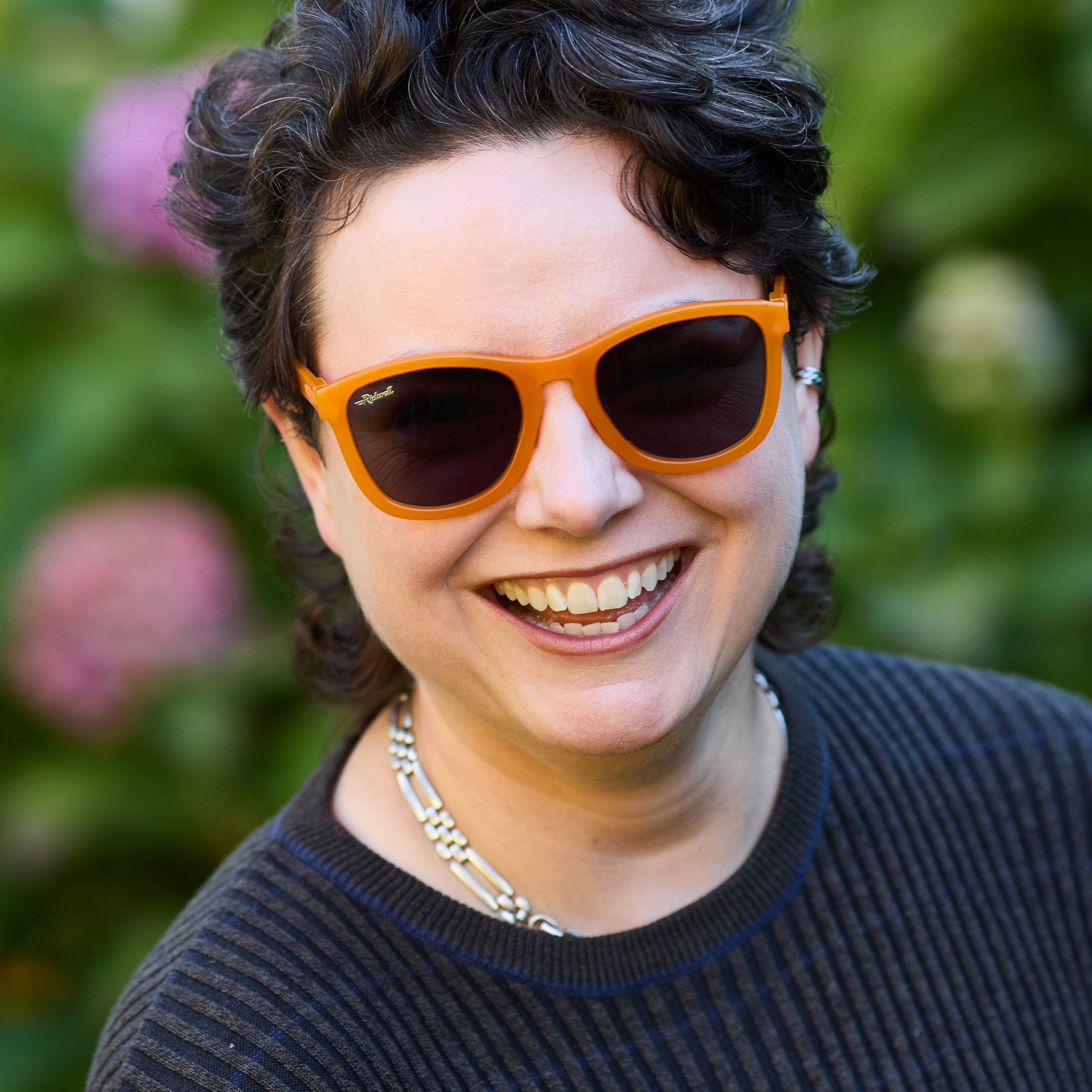smiling woman wearing pill bottle sunglasses