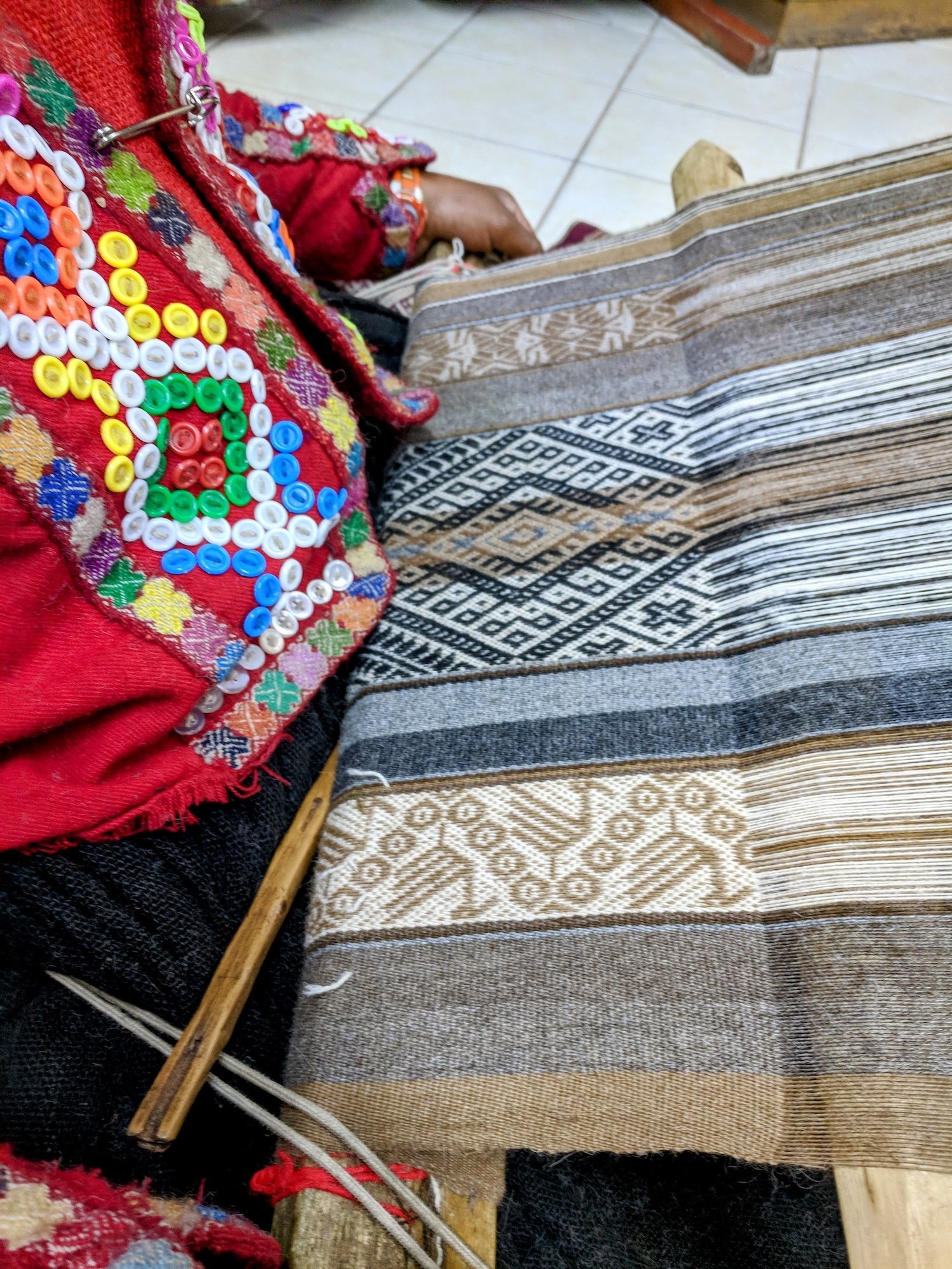 Watch, mesmerized, as the women's skillful hands fly across the loom to create elaborate designs.
