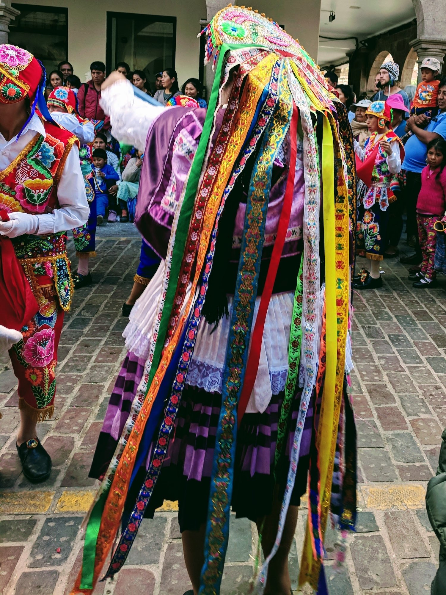 A woman dressed up for dance, with long colorful ribbons.