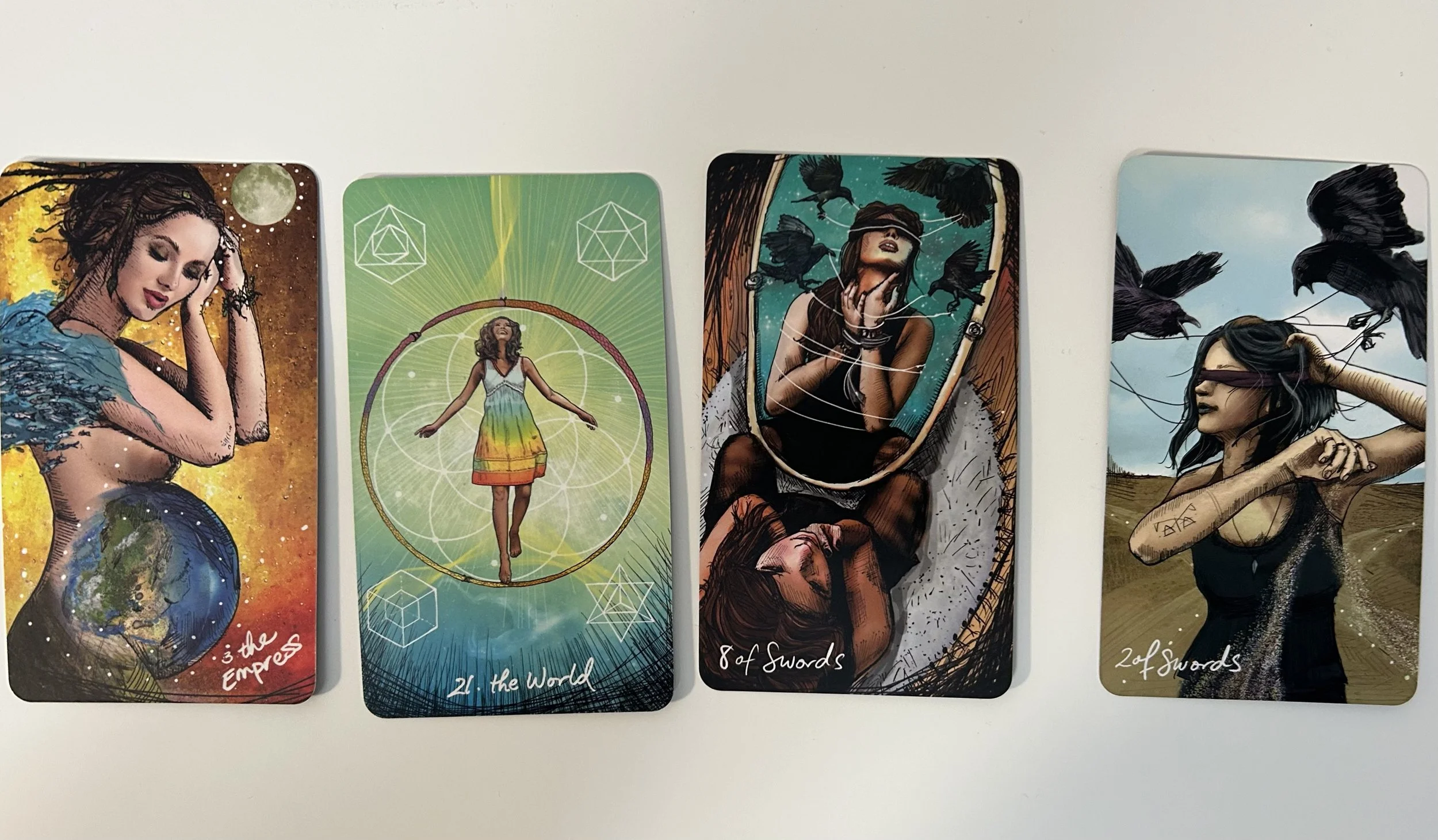 There are 4 Tarot Cards - The Empress, The World, 8 of Swords, and 2 of Swords