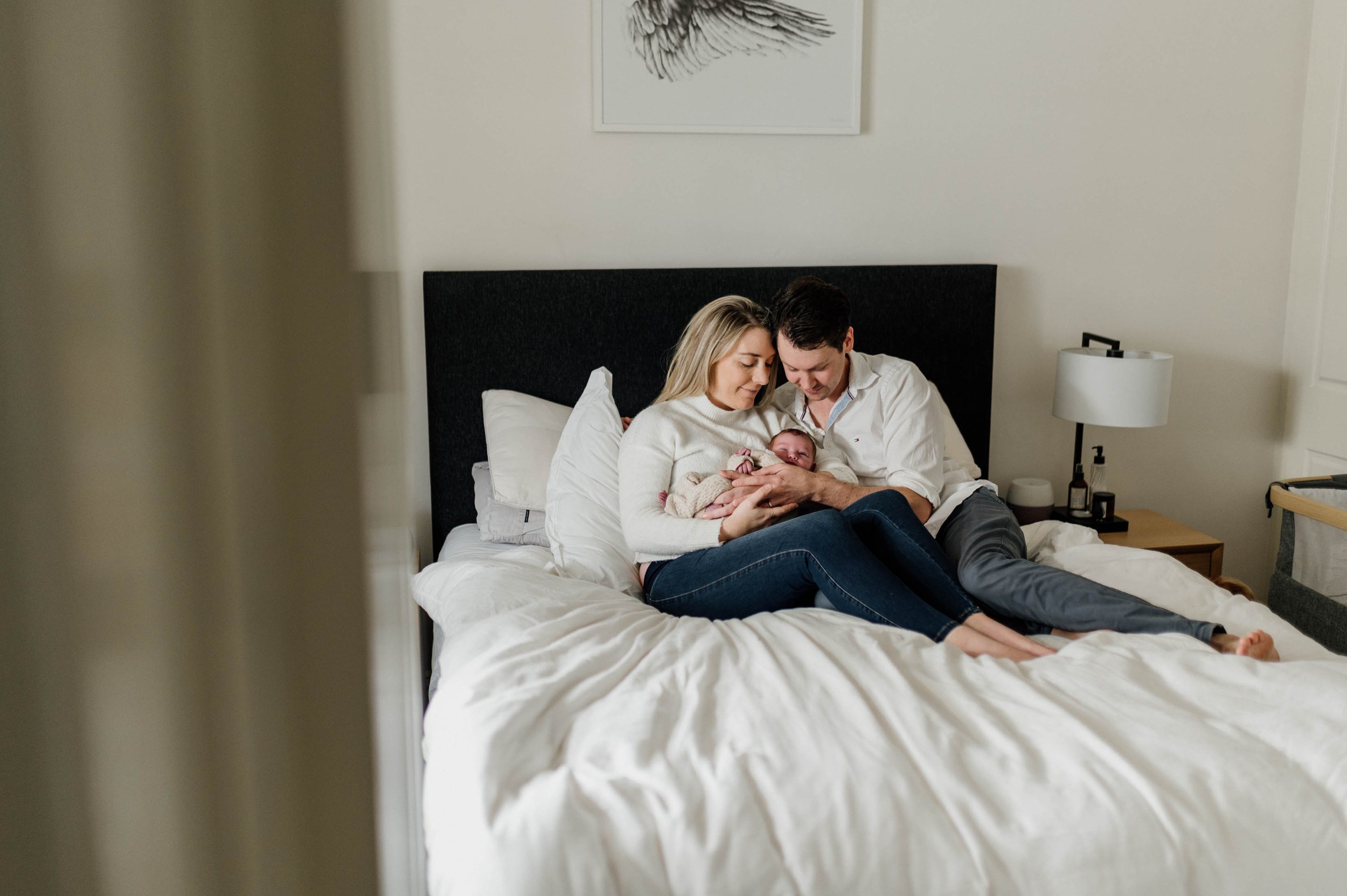 parents on bed with baby