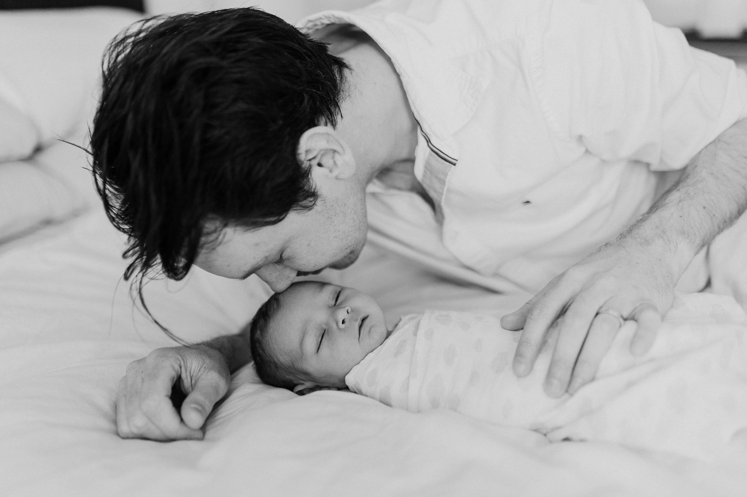 dad laying next to baby