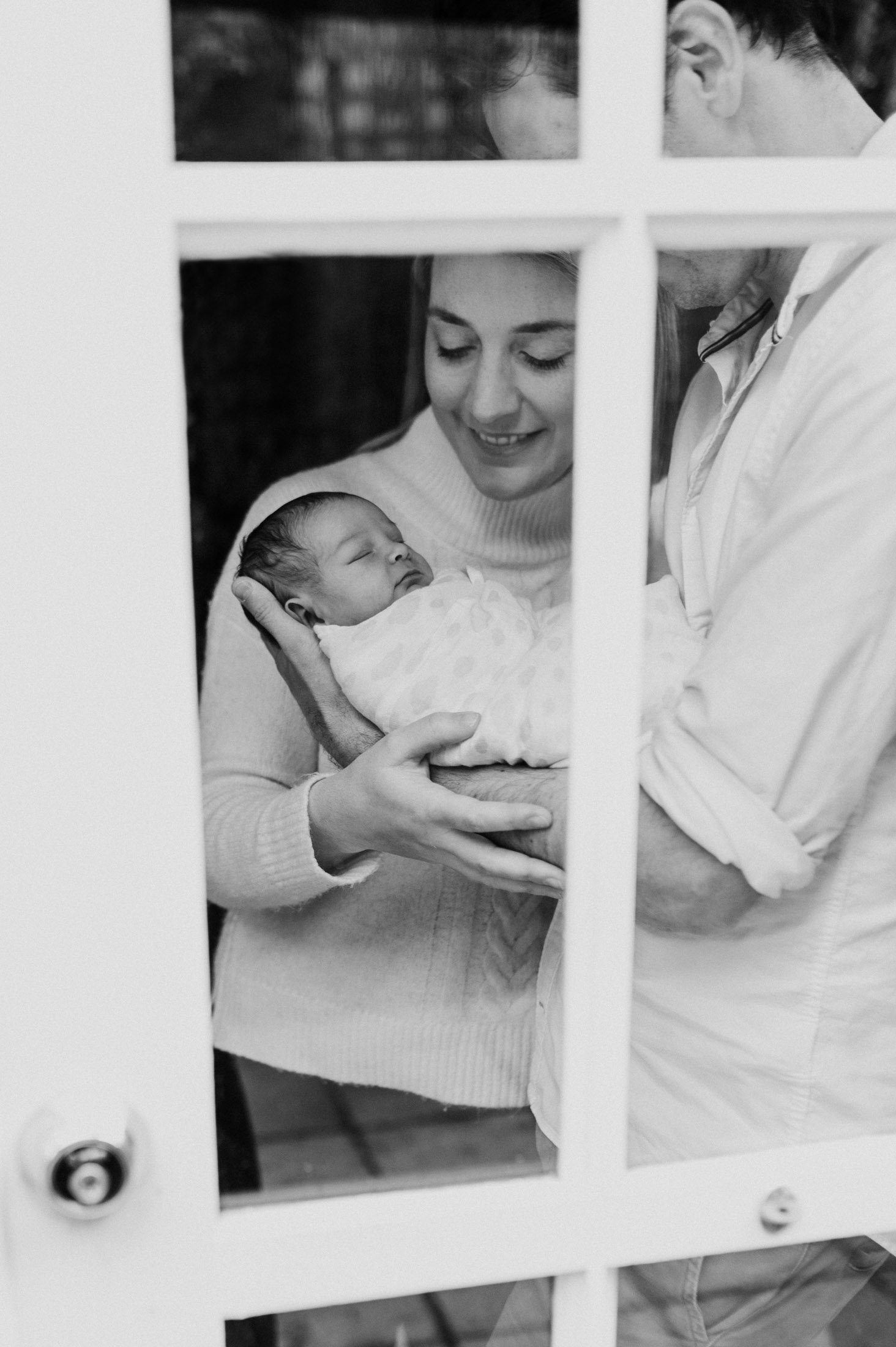 looking through window at family with baby