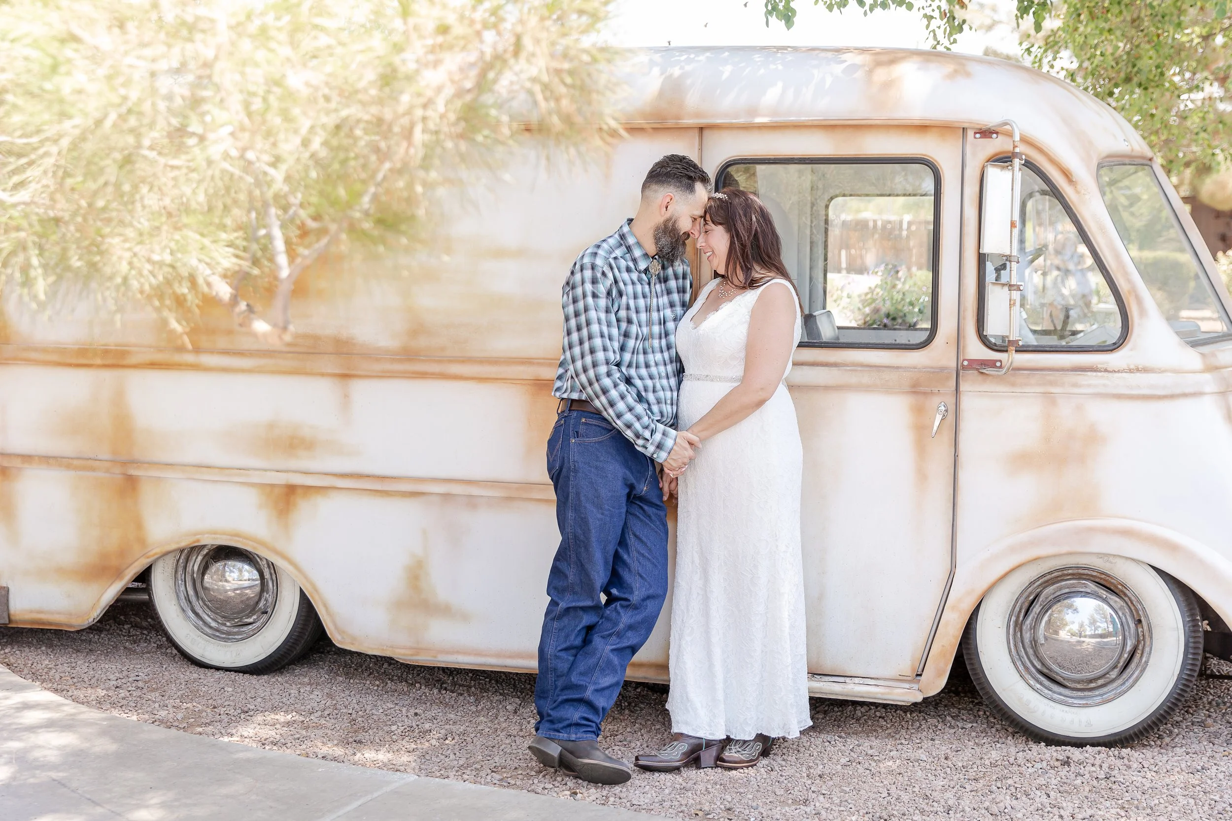 newlyweds leaning on the side of a metro van
