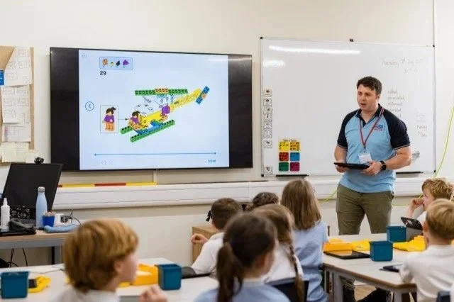 A Hyett Education instructor acting on behalf of the Royal Air Force briefs students on their task for building and coding a LEGO helicopter