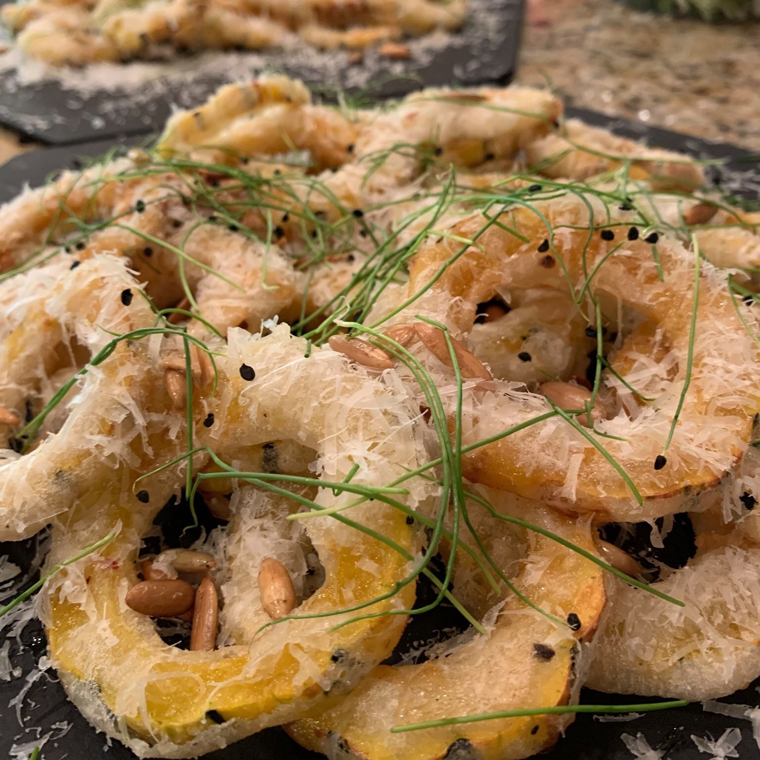 Delicata Squash Donuts; tempura fried and served with fried pepita seeds, pecorino cheese, and chili honey
