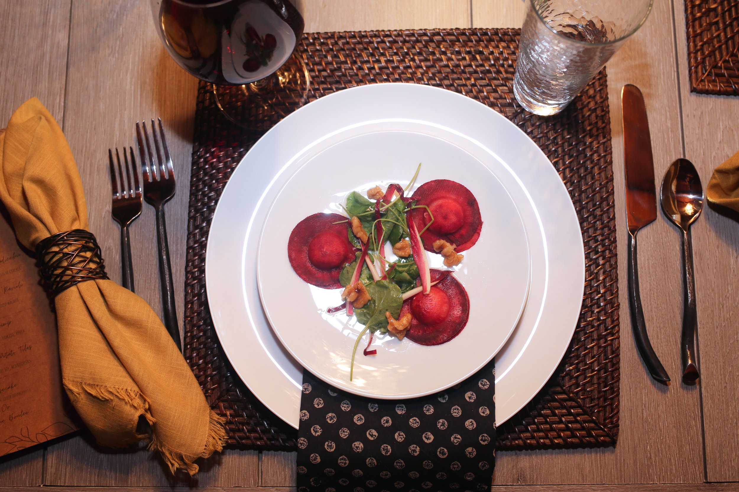 Beet "Ravioli" stuffed with herbed goat cheese, and topped with endive, watercress, candied walnuts, and a walnut vinaigrette