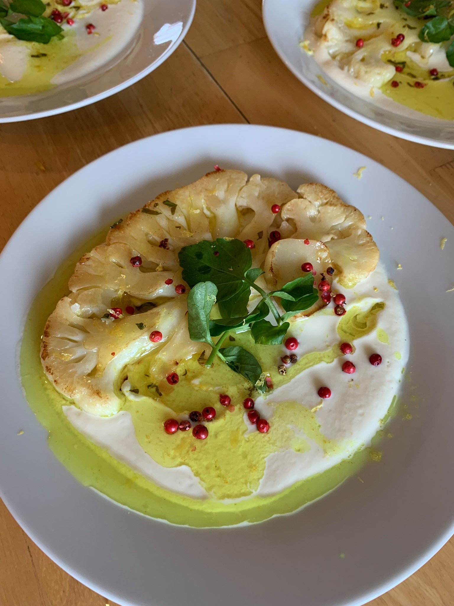 Roasted Cauliflower with cauliflower puree, turmeric brown butter sauce, watercress, and pink peppercorn