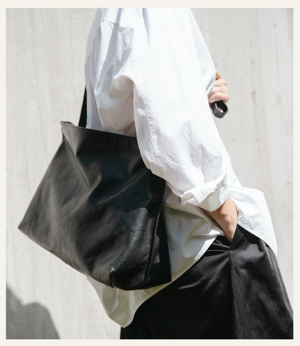 Lihann George Tani Bag in black crushed grain leather worn over the shoulder — Sabine Kohler Boutique1.png