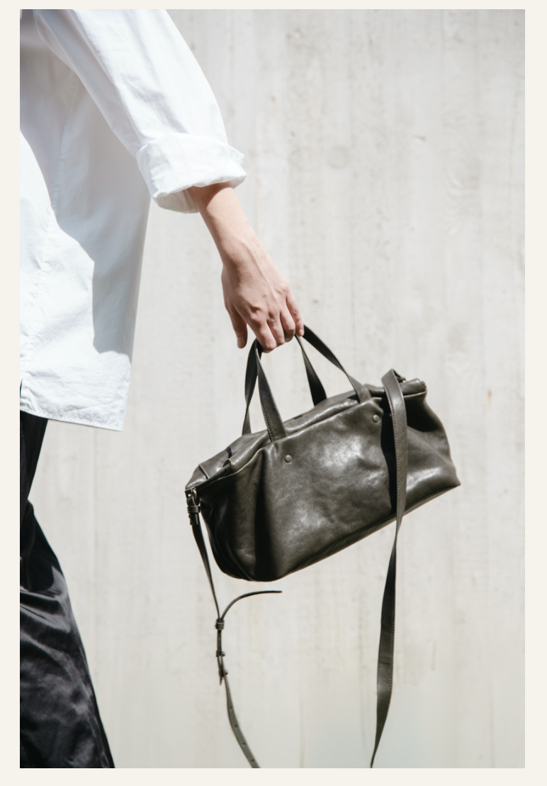 Lihann George Lili Bag in matte natural grain leather held under the arm — Sabine Kohler Boutique2.png