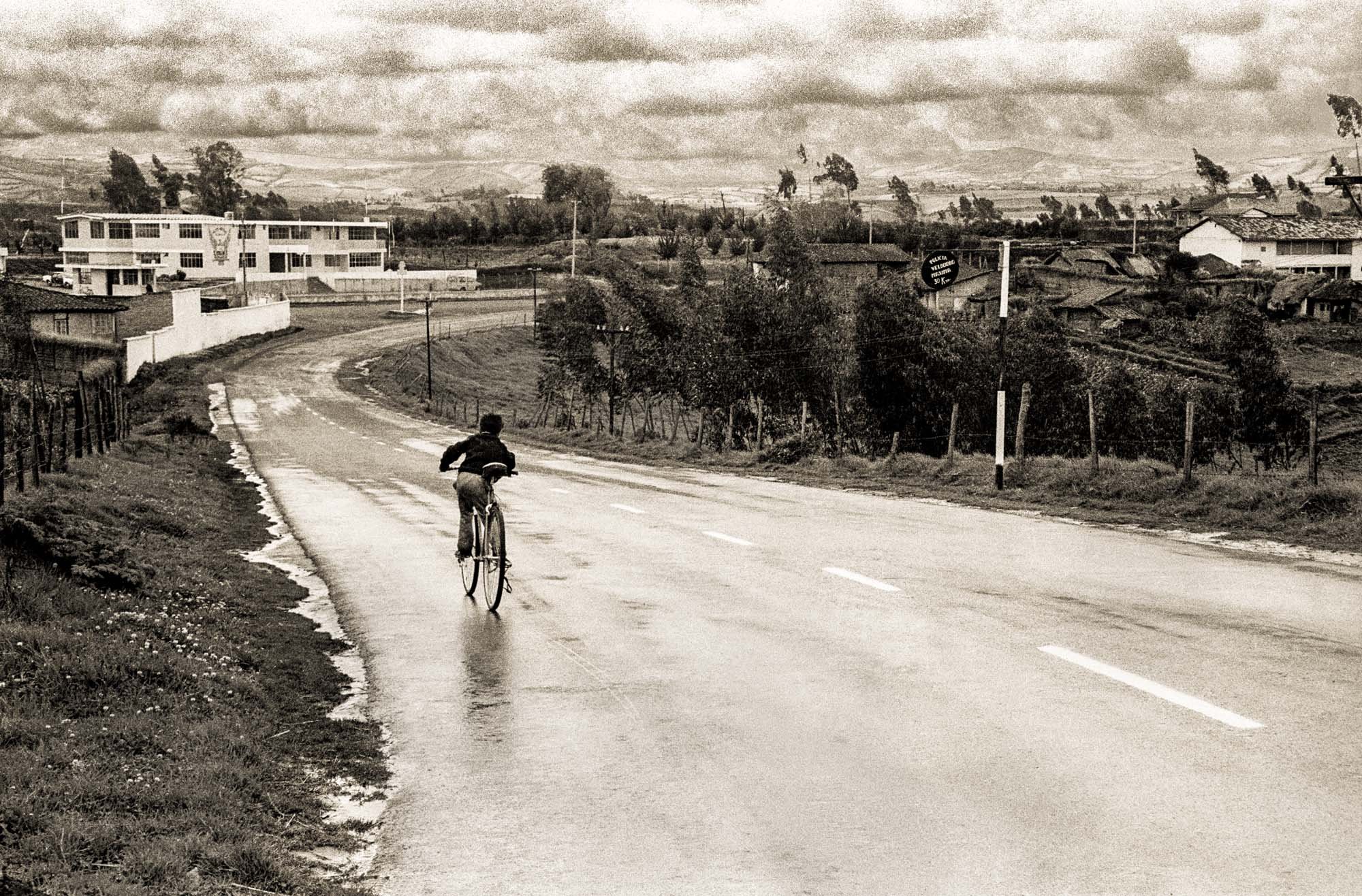 Bicycling Boy on Wet Road