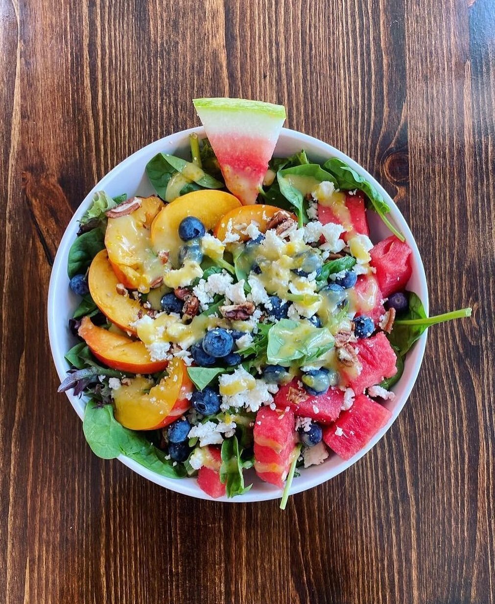 Try our Summer Salad! Watermelon, nectarines, blueberries, strawberries, sunflower seeds and feta on mixed greens with champagne dressing on top!