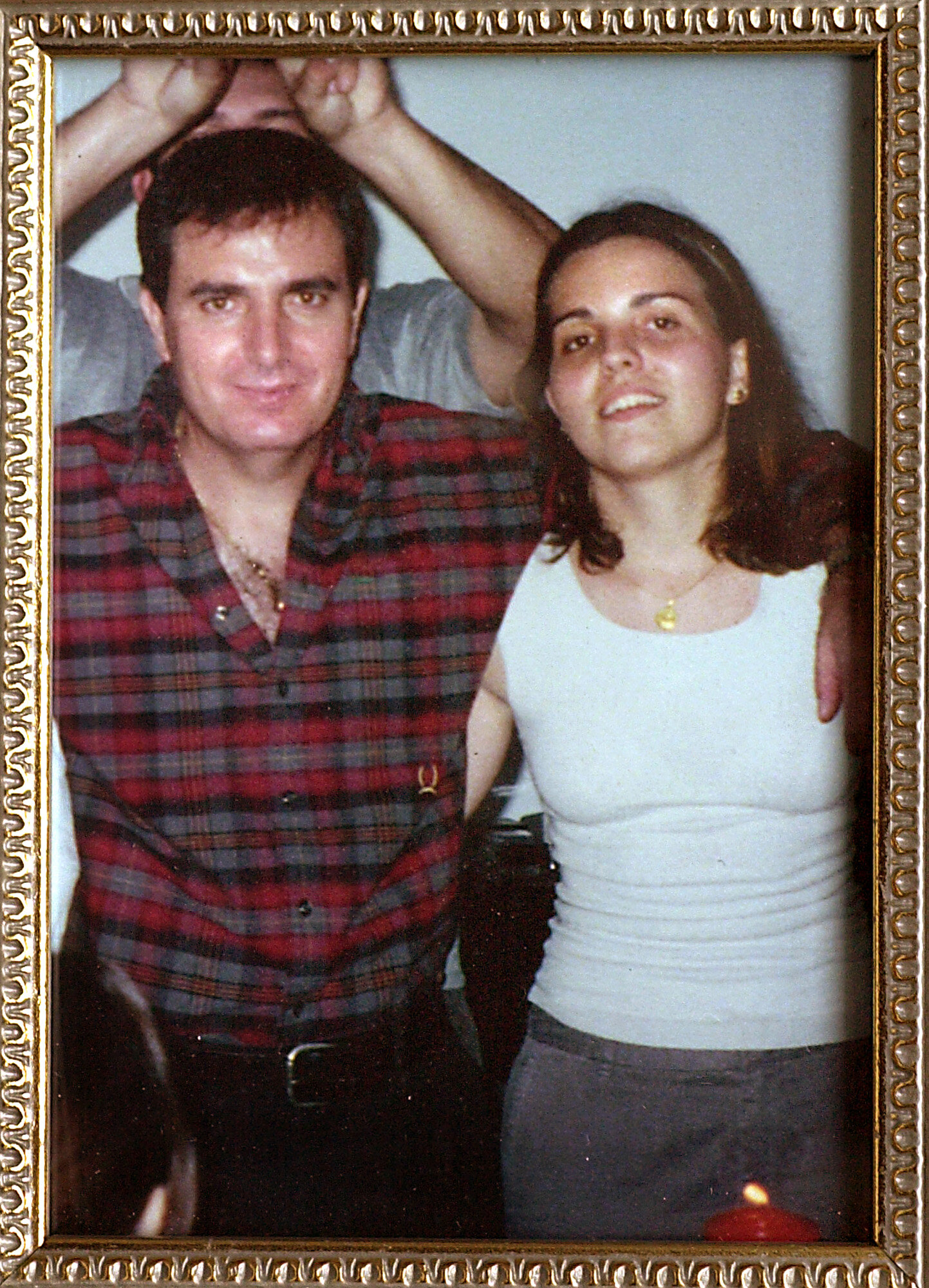  Jacqui displays this photo of her with her father as a memento from her old life. Taken just before she left Venezuela for Austin in 1999, it's a reminder of what she lost, but also of what she still has: her memories and her father. 