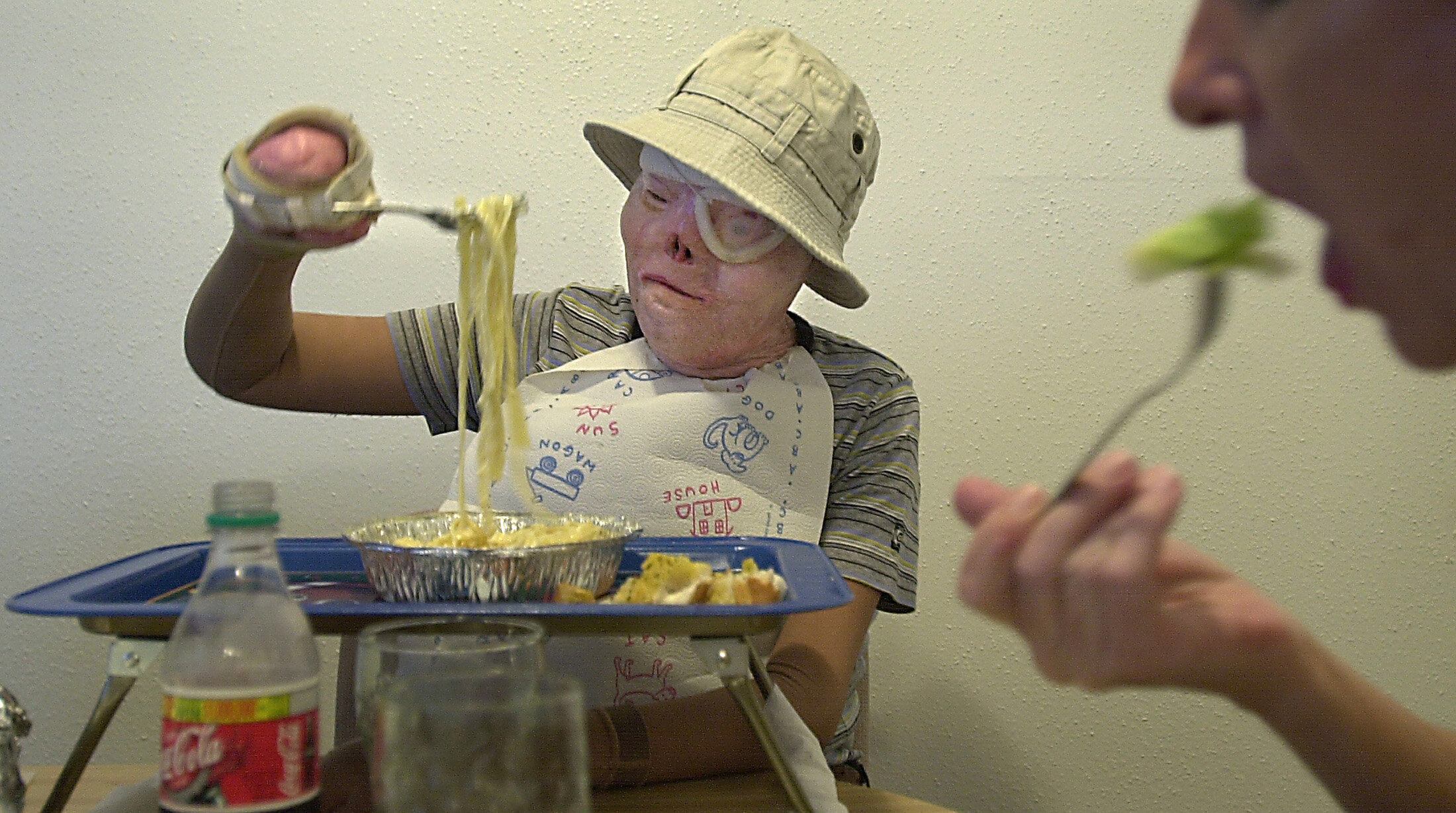  With a little help from a Velcro splint on her hand, Jacqui could serve herself fettuccine alfredo in the summer of 2001. Whenever she does something new, her father cheers. 'Look, you're eating by yourself,' Amadeo exclaimed one day as he dabbed ma