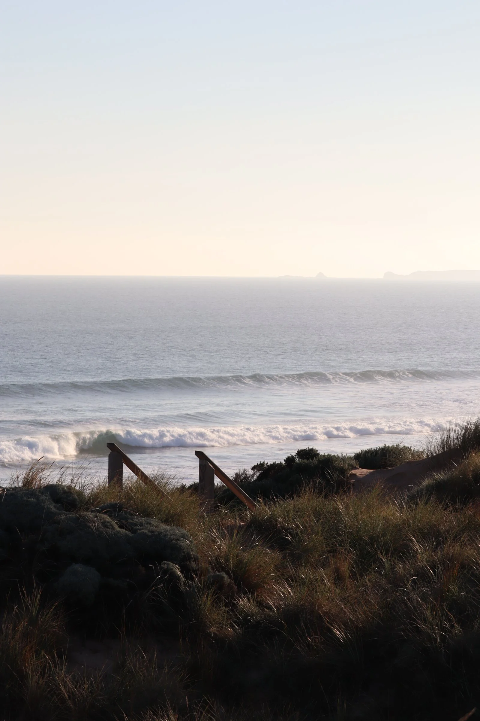 Boardwalk through dune grass to the ocean, Phillip Island