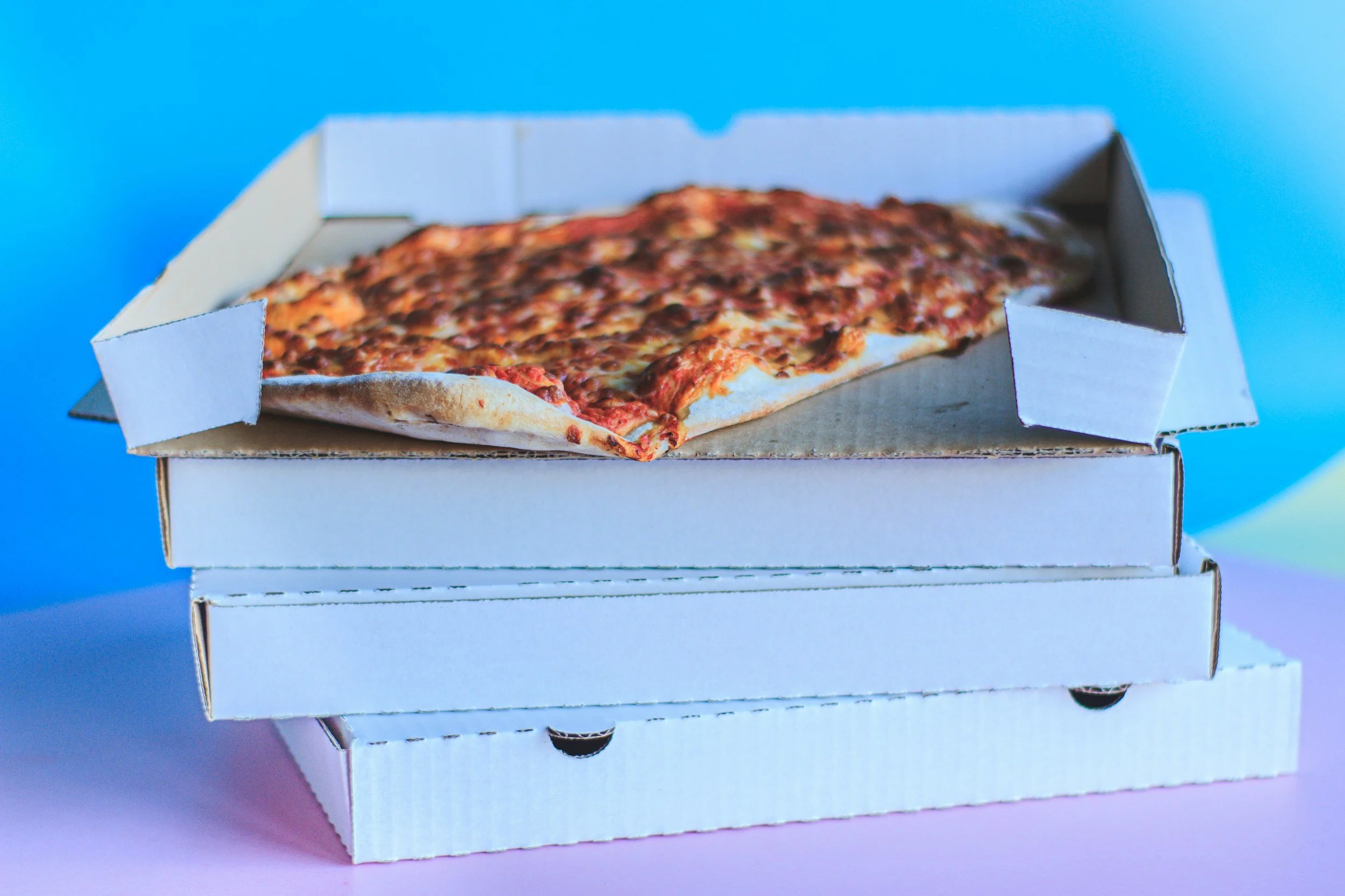 Take out order of a stack of pizzas in boxes