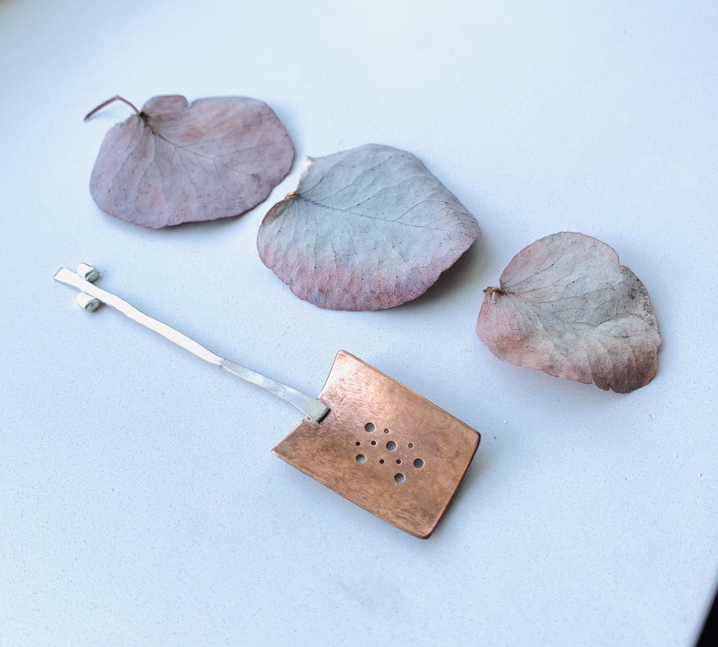 Silver and copper olive spoon