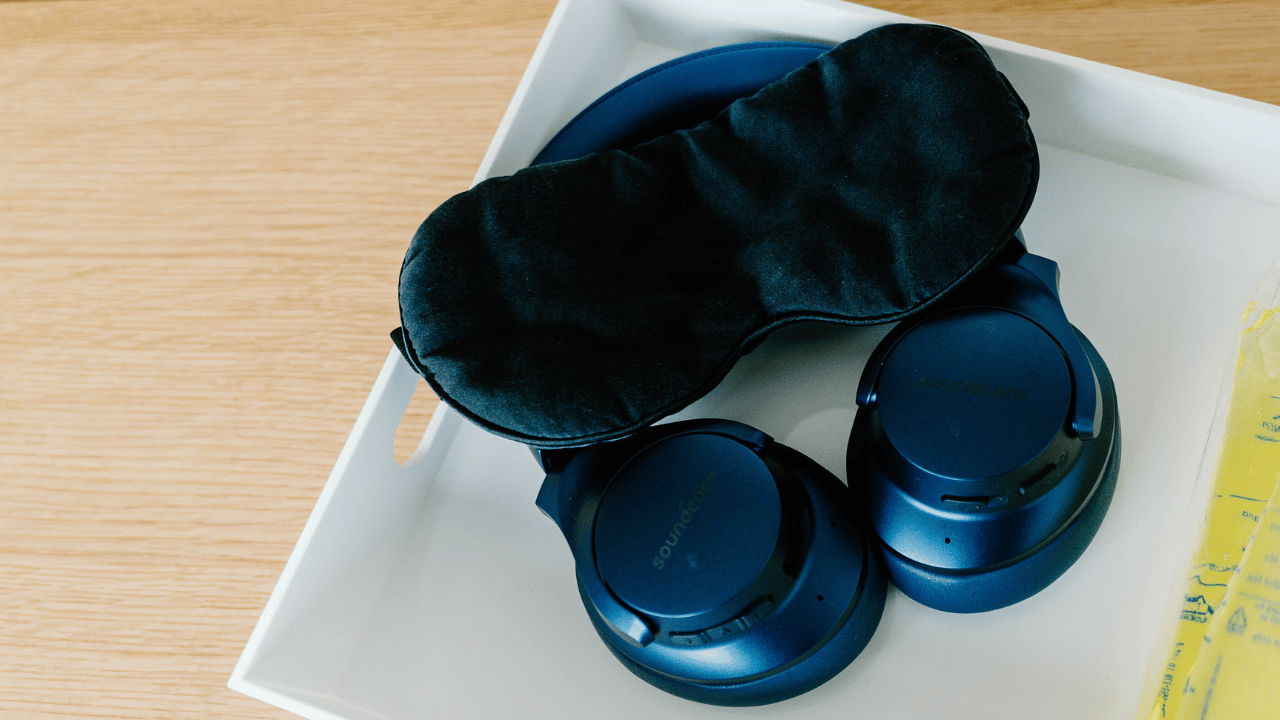 sleeping mask and headphones on a tray