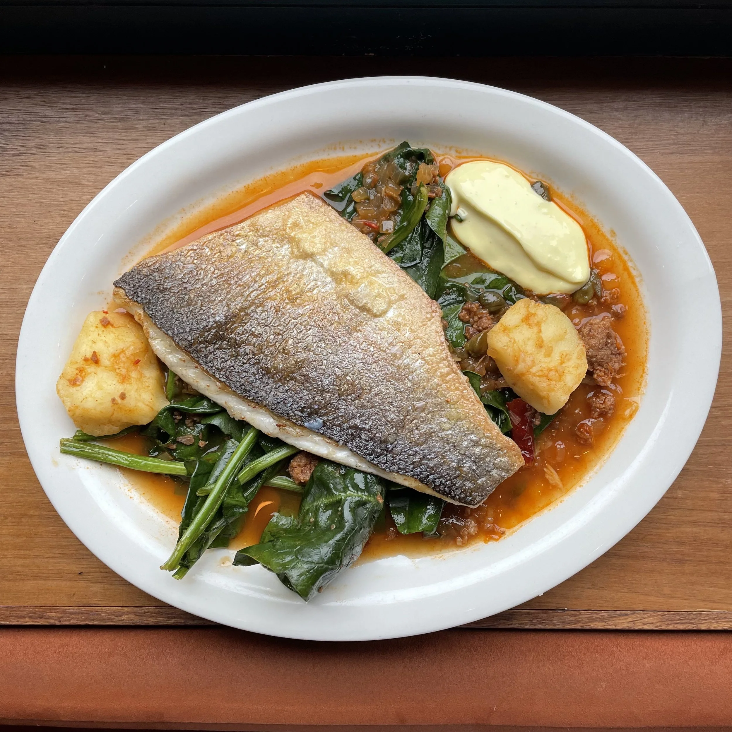 Crisped Branzino, Chorizo & Paprika Brodo, Wilted Greens and Aioli