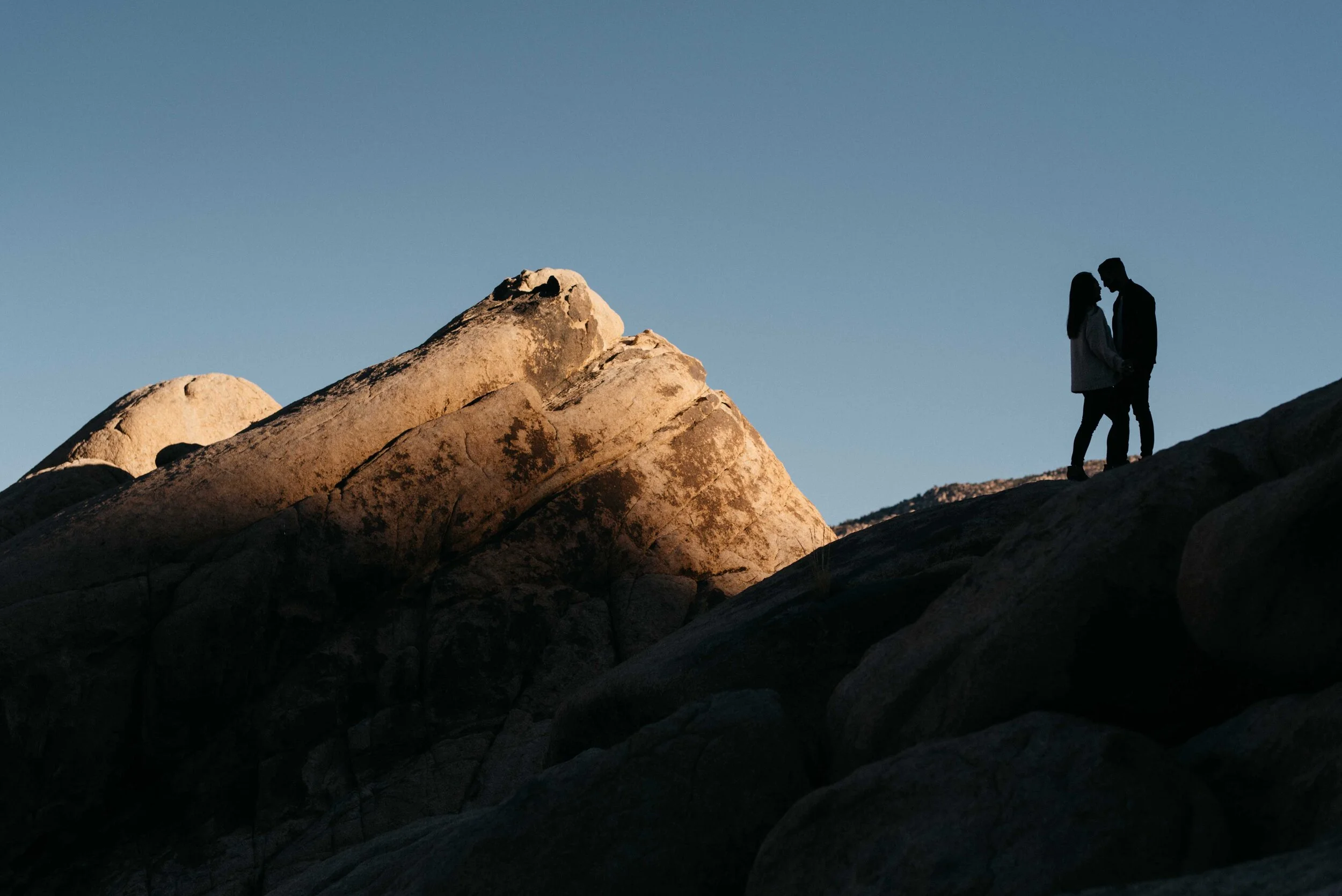 Couple stands together at Joshua Tree National Park