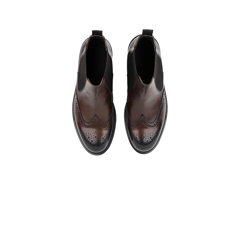 Top view of brown brogue Chelsea boots with black elastic sides