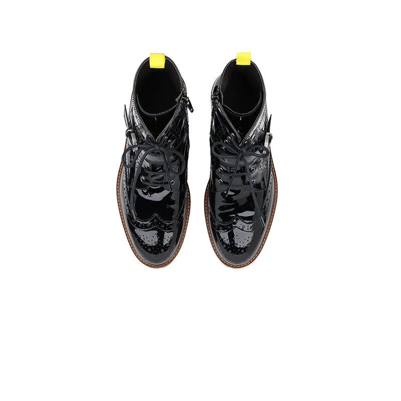 Top view of black glossy dress shoes with yellow pull tabs