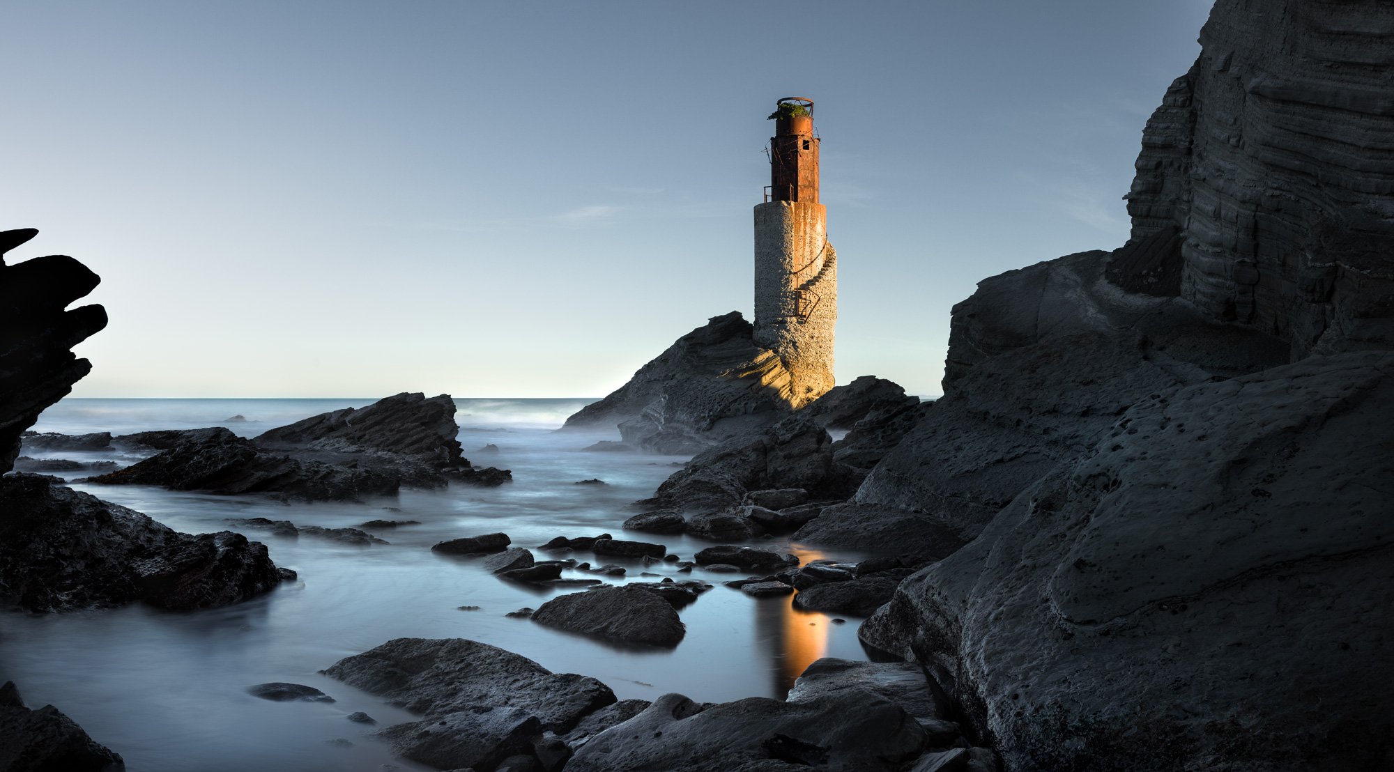Tuahine Point lighthouse basking in the afternoon rays of a setting sun at the south end of Wainui Beach - a super high quality fine art print made in New Zealand by Damon Meade
