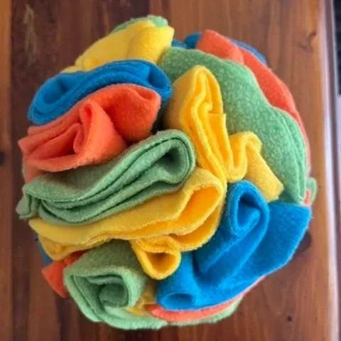 Snuffle ball for dogs, made out of bright coloured felt. Enrichment for dogs, boredom buster.
