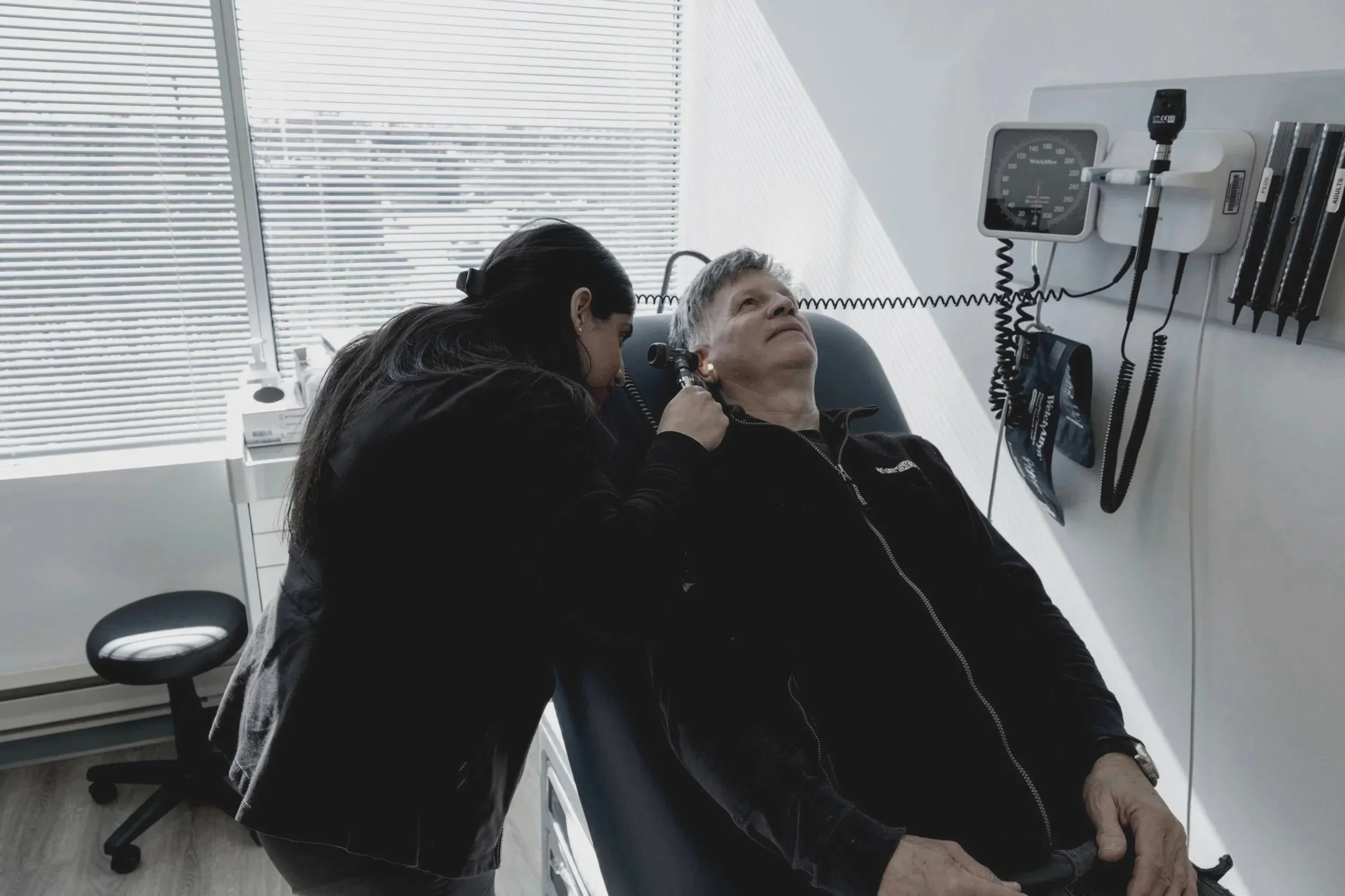 nurse examining patient on clinic bed