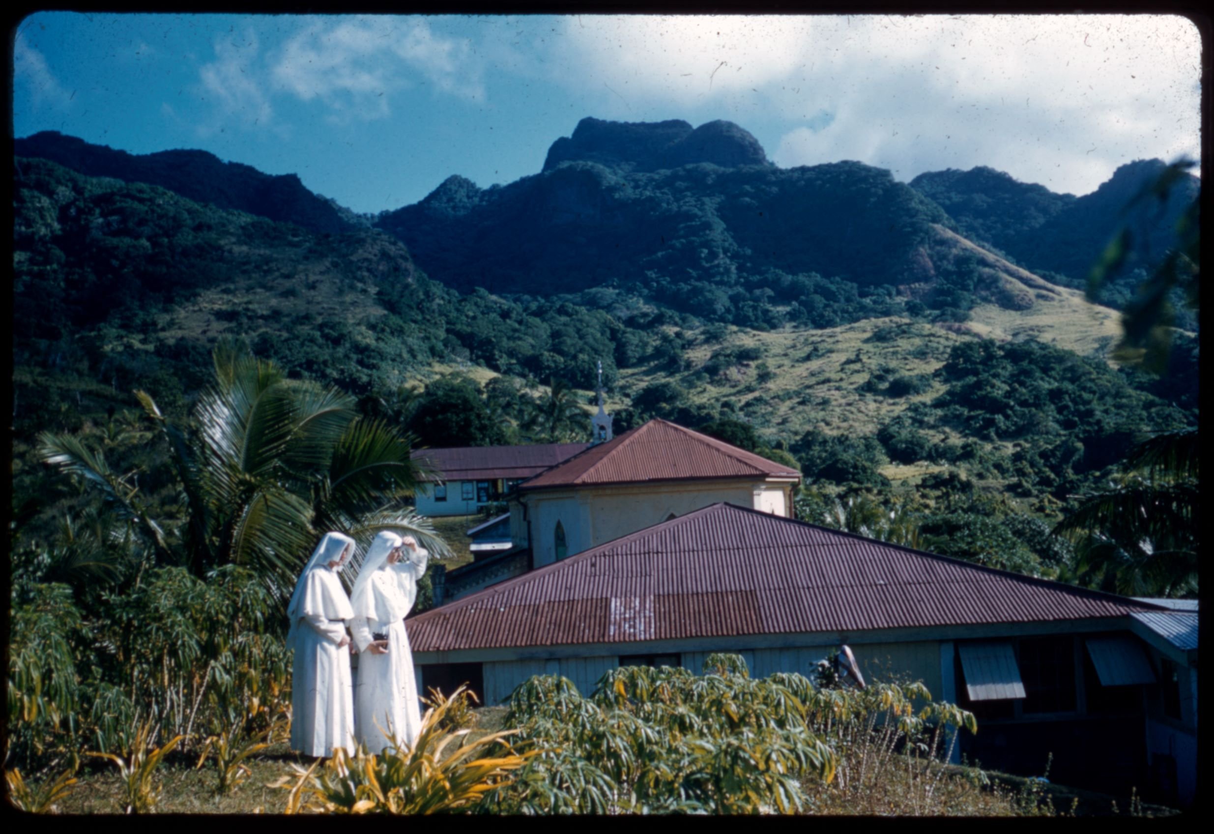 A Sister of Compassion and Sister of Charity with the buildings of St Teresa’s Novitiate and Maryhill Convent in the background, ca 1959-ca 1965