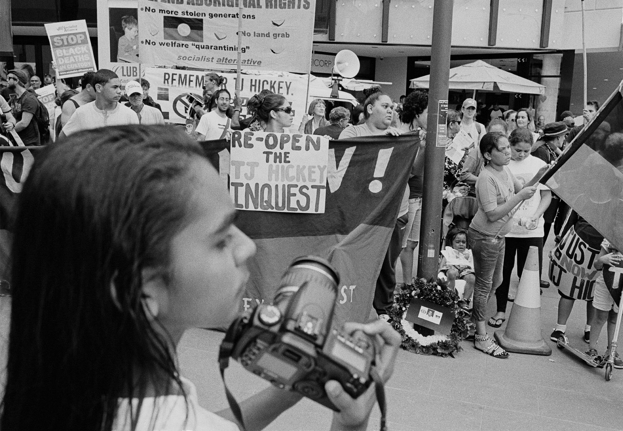    Cynthia Hickey taking photos of the march commemorating the ninth anniversary of the death of her brother Thomas (TJ) Hickey, Redfern, 14 February 2013. The participants marched to NSW Parliament to hand over a petition demanding a new inquest int