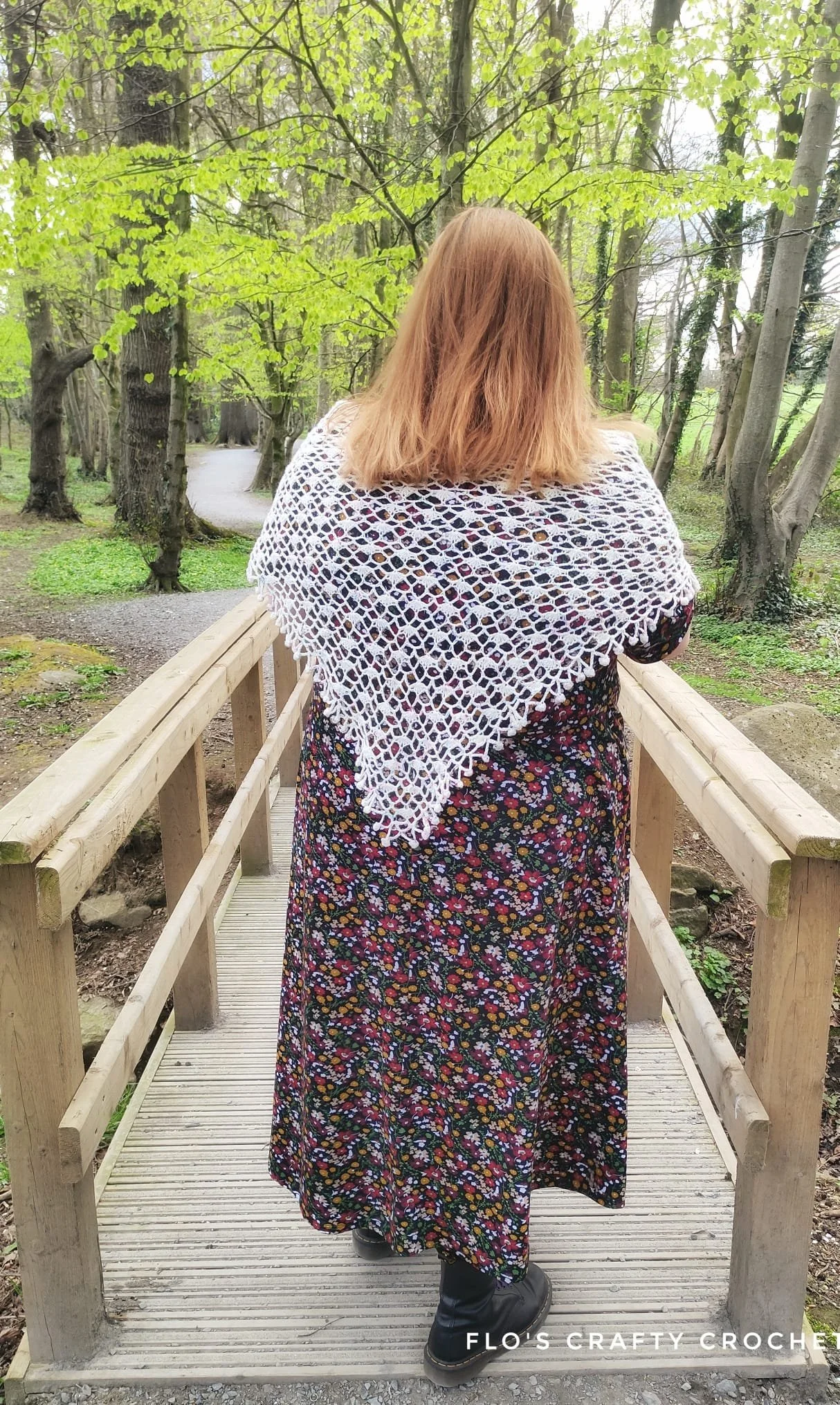 Woman on a bridge wearing a shawl