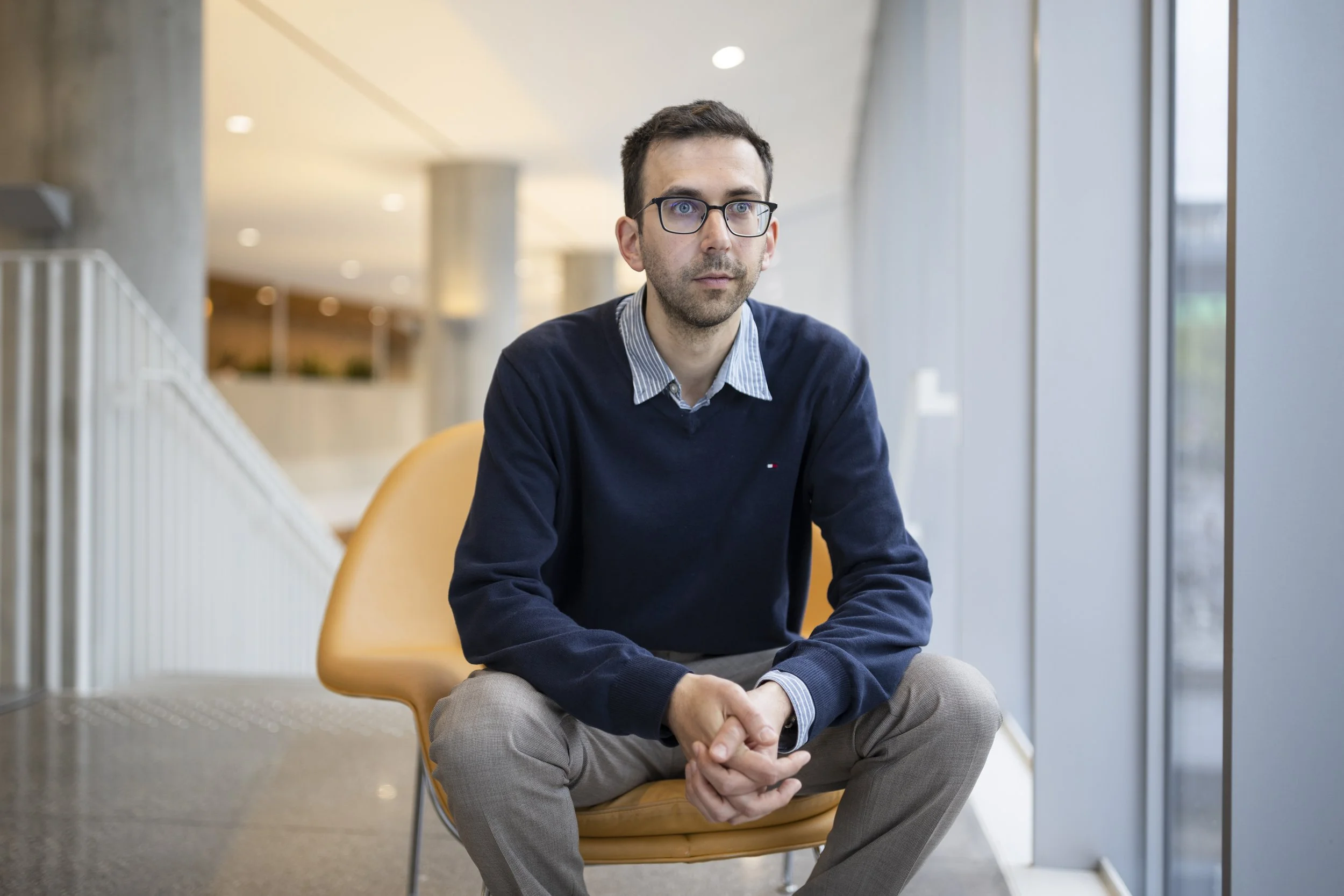 SRI Faculty Affiliate Nicolas Papernot sitting in an orange chair.