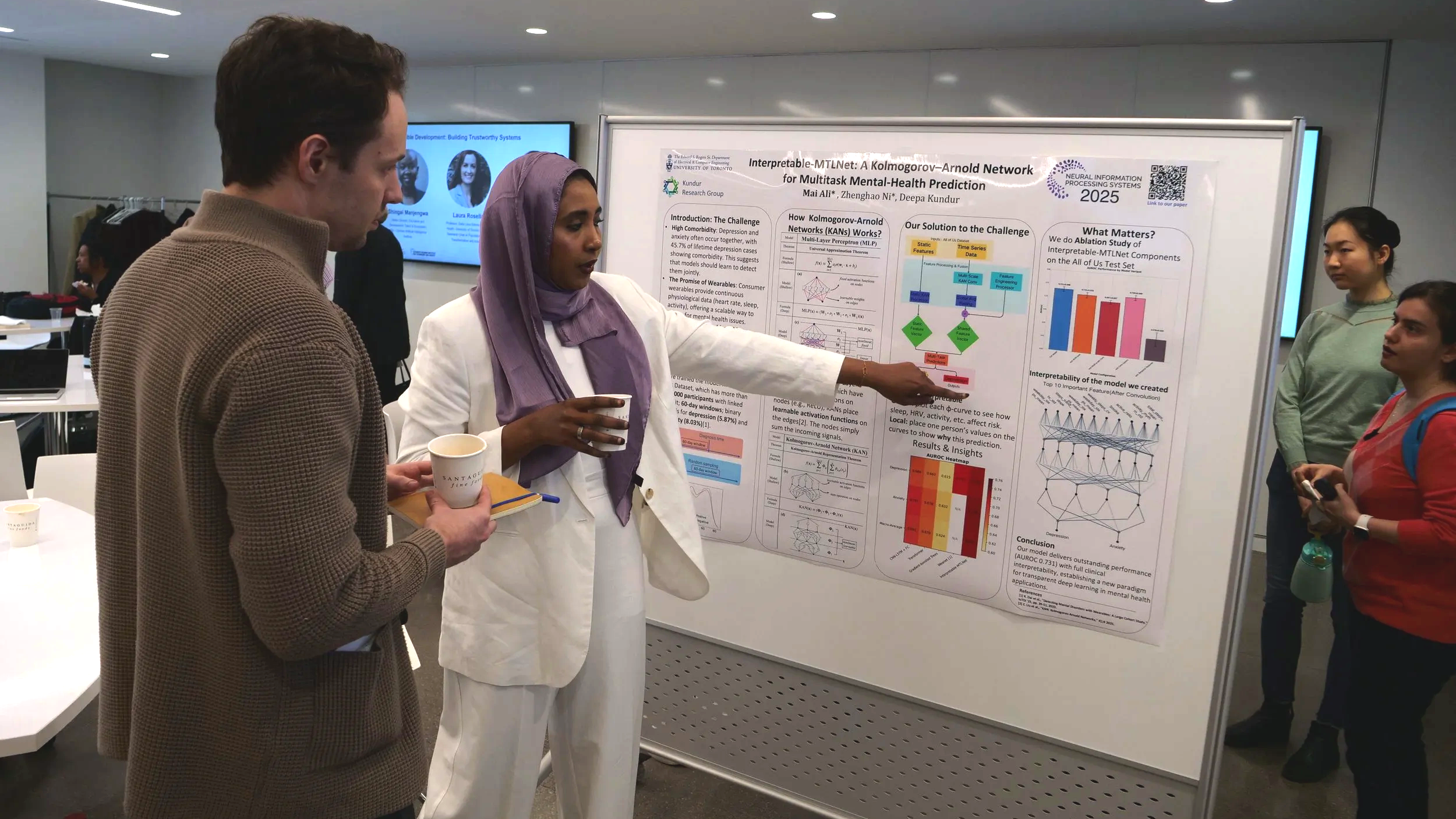 Photo of Graduate Fellow Mai Ali discussing her research during the poster session.