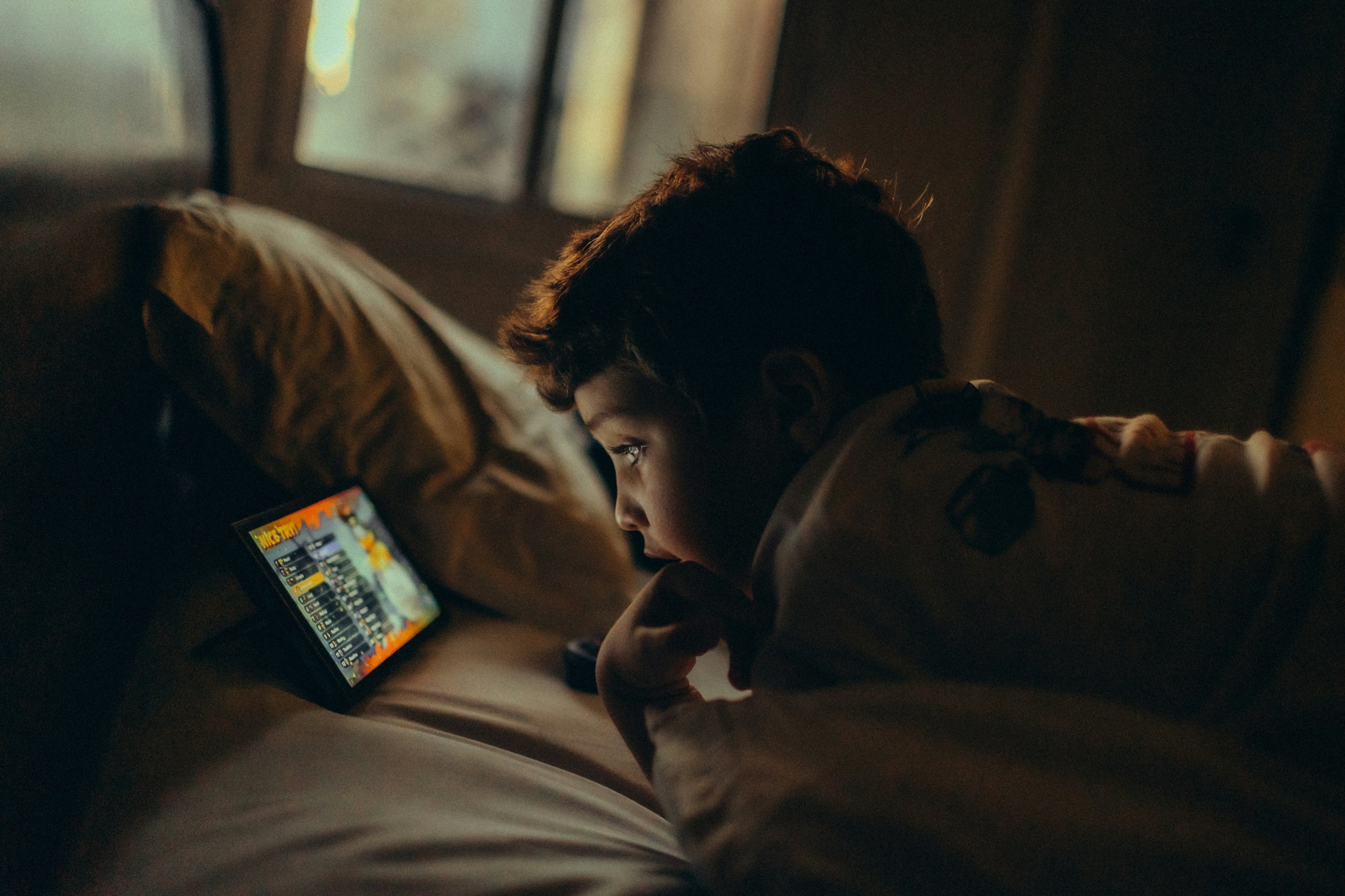 A child looking at a screen.