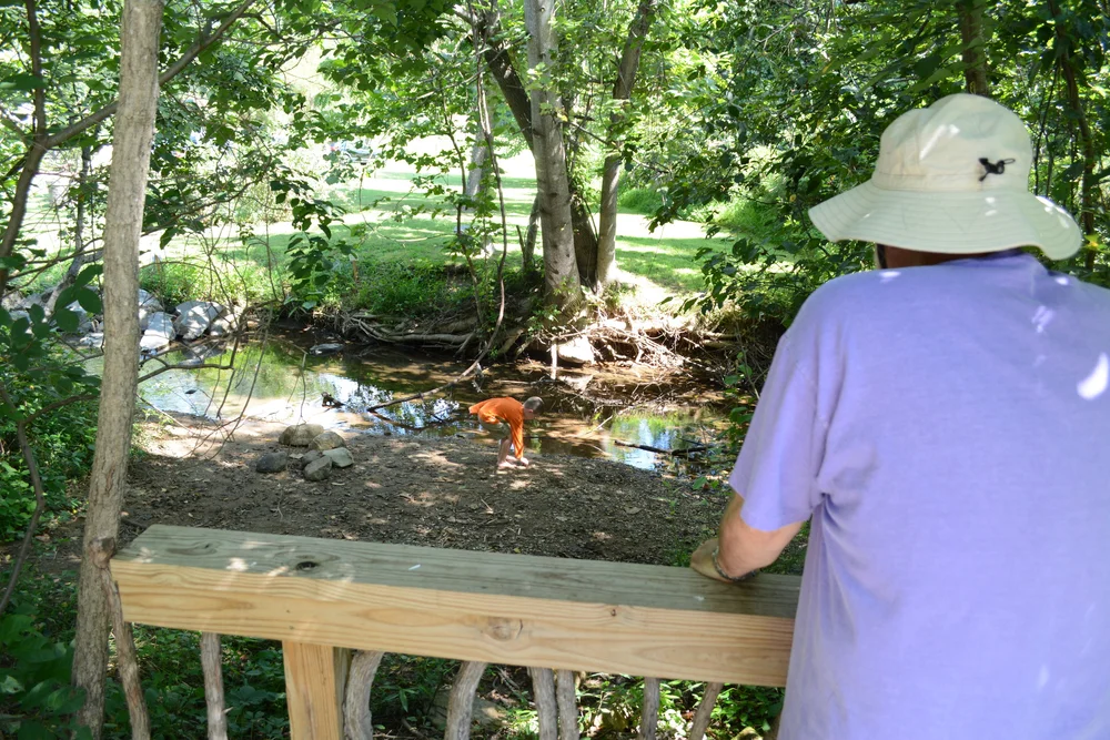 Every child (and adult) has to explore the welcoming creek.