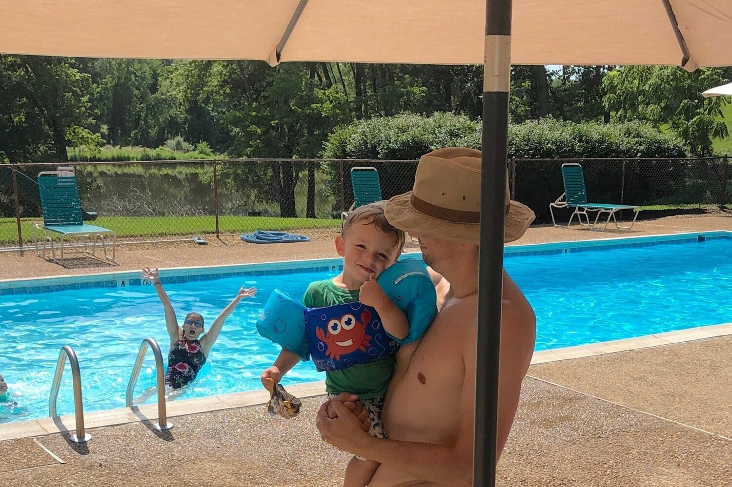   While Megan Siegel clowns for the camera in the background in the  Rodes Farm pool in the valley , Weston Siegel and son Taylor share a moment. The property owners said their Sunday morning visit to the pool was “idyllic.”  