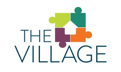 Logo for The Village featuring interconnected puzzle pieces in green, purple, orange, and teal.