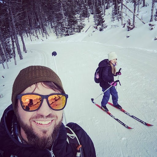 Chad and his daughter skiing on a trail in Clarenville