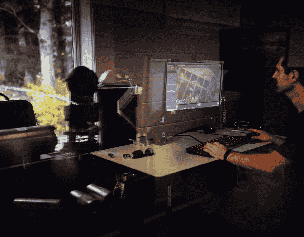 Man sitting at computer looking at inspection data