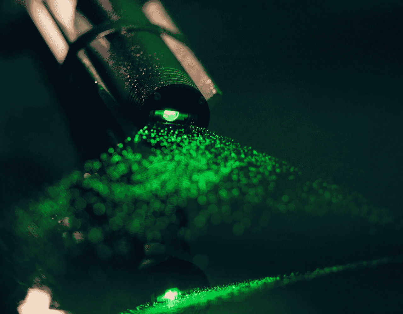 Close-up of a SubC MantaRay Laser emitting a green laser sheet